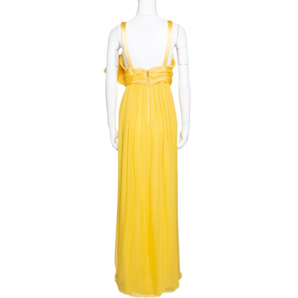 Designed in a flattering silhouette, this silk maxi number from Dolce & Gabbana is a head-turner! It looks lovely in yellow and features ruched details throughout. It flaunts a wide bow on the waist and a V-neckline. It is equipped with a zip