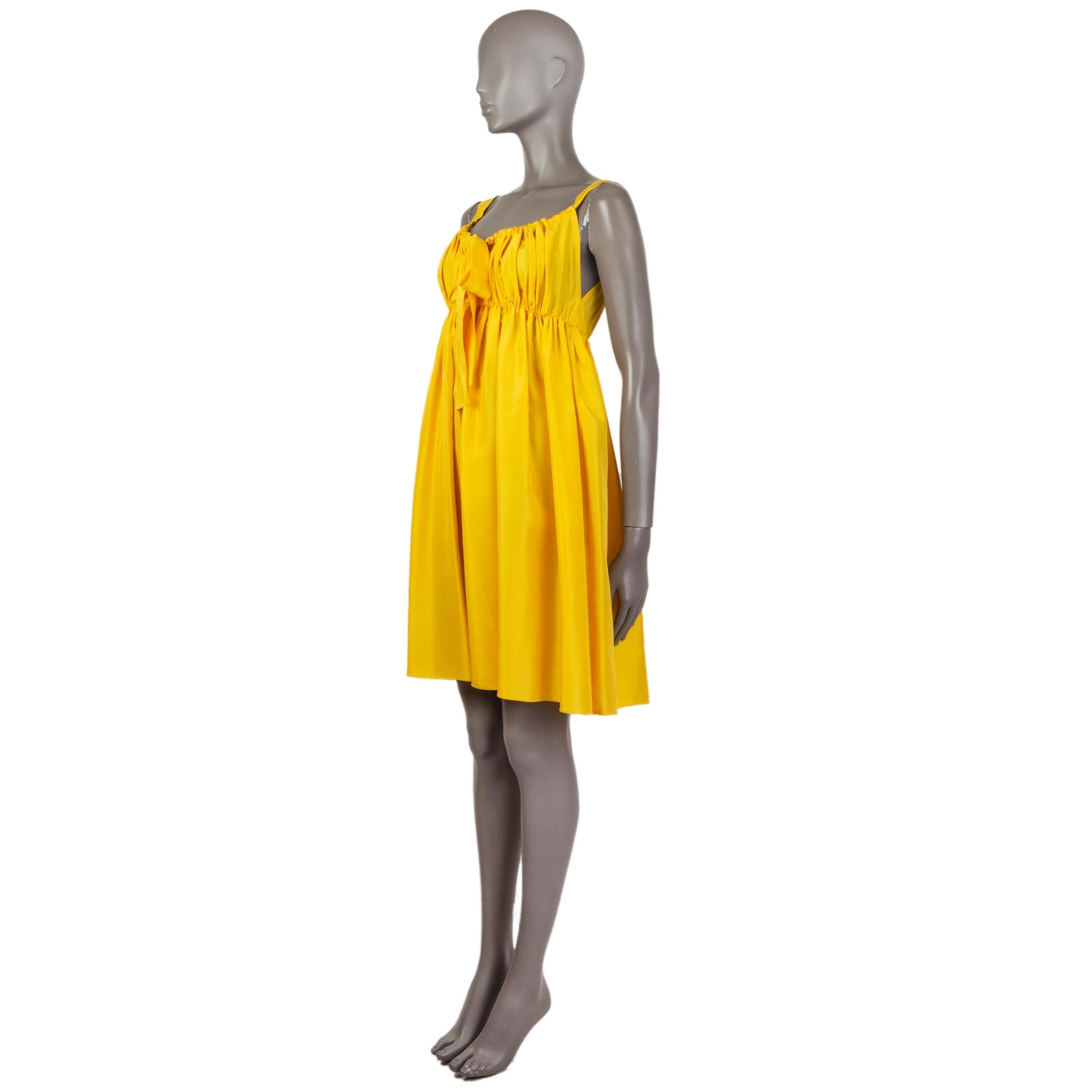 Dolce & Gabbana sleeveless summer dress in yellow silk (100%) with a scoop neck. Has a front bow. Unlined. Has been worn and is in excellent condition. 

Tag Size 40
Size S
Shoulder Width 30cm (11.7in)
Bust 54cm (21.1in) to 56cm (21.8in)
Waist 54cm