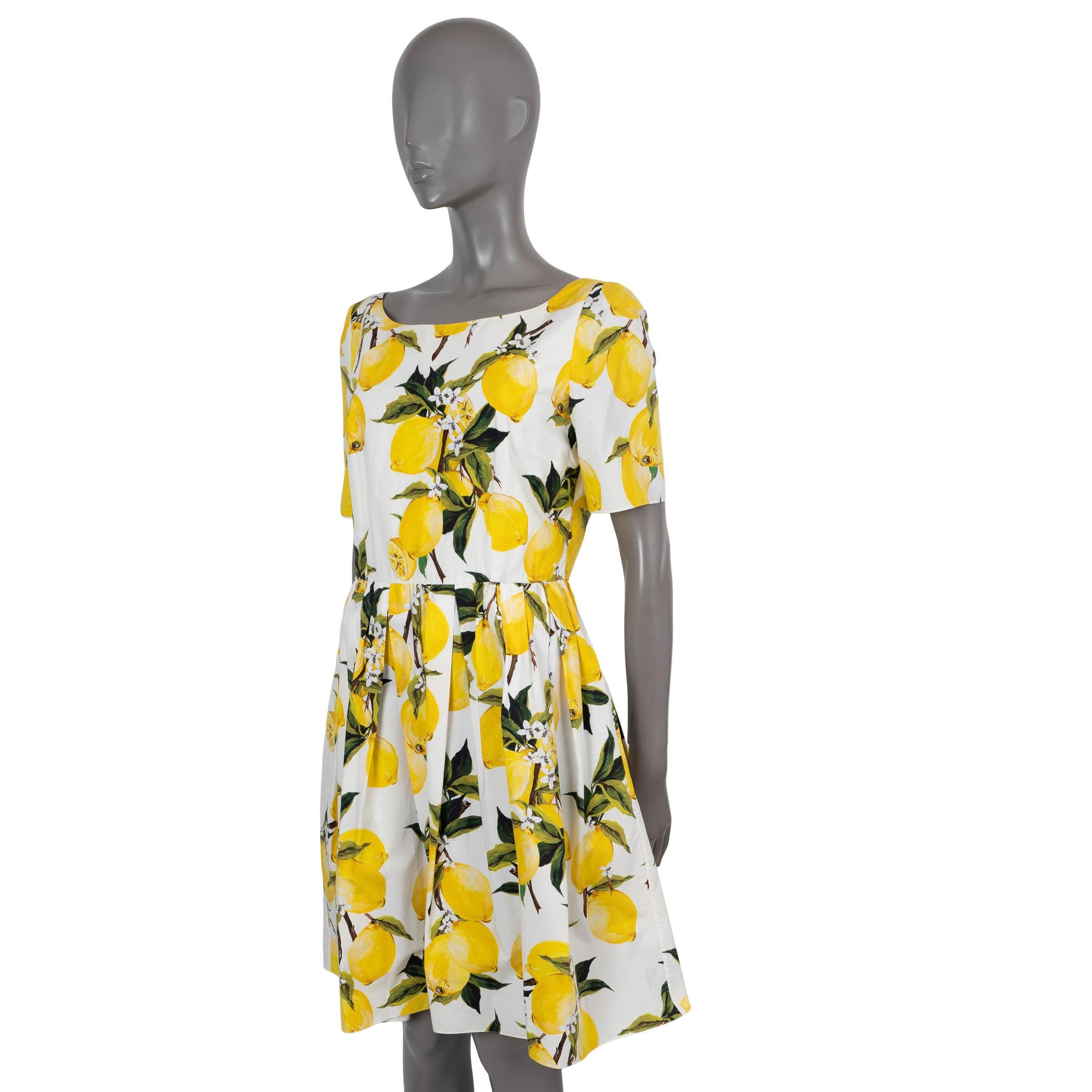 100% authentic Dolce & Gabbana poplin dress white cotton (100%) with lemon print in yellow and green. Features a round neck, short sleeves and pleated skirt. Opens with a concealed zipper in the back and is lined in cotton (100%). Has been worn and