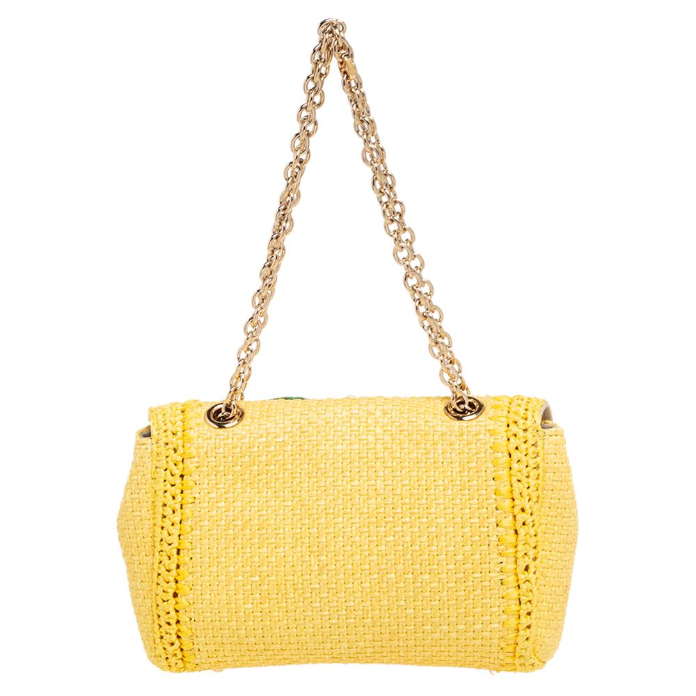 In a vibrant shade of yellow, this Dolce & Gabbana bag will transform your outfit into a combination of classic and contemporary. Made from woven raffia, its exterior is designed with a crystal-embellished detail on the front flap and shoulder
