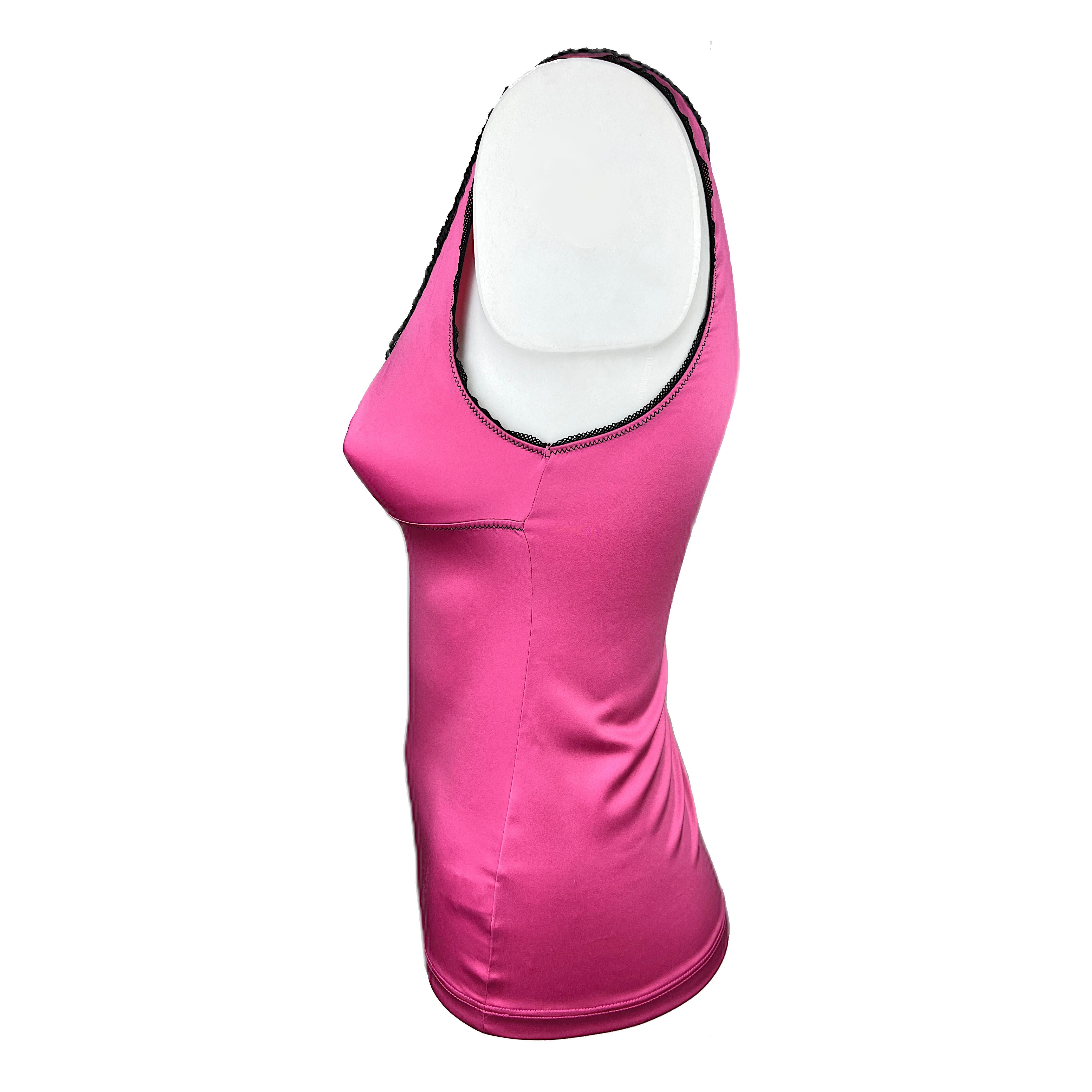 This is a sexy tank top of an intense pink with a fine black lace attached to the shoulder and collar hems. It features a golden D&G logo on the breast and fabric is very soft and comfortable. The size corresponds to an International Small.

About