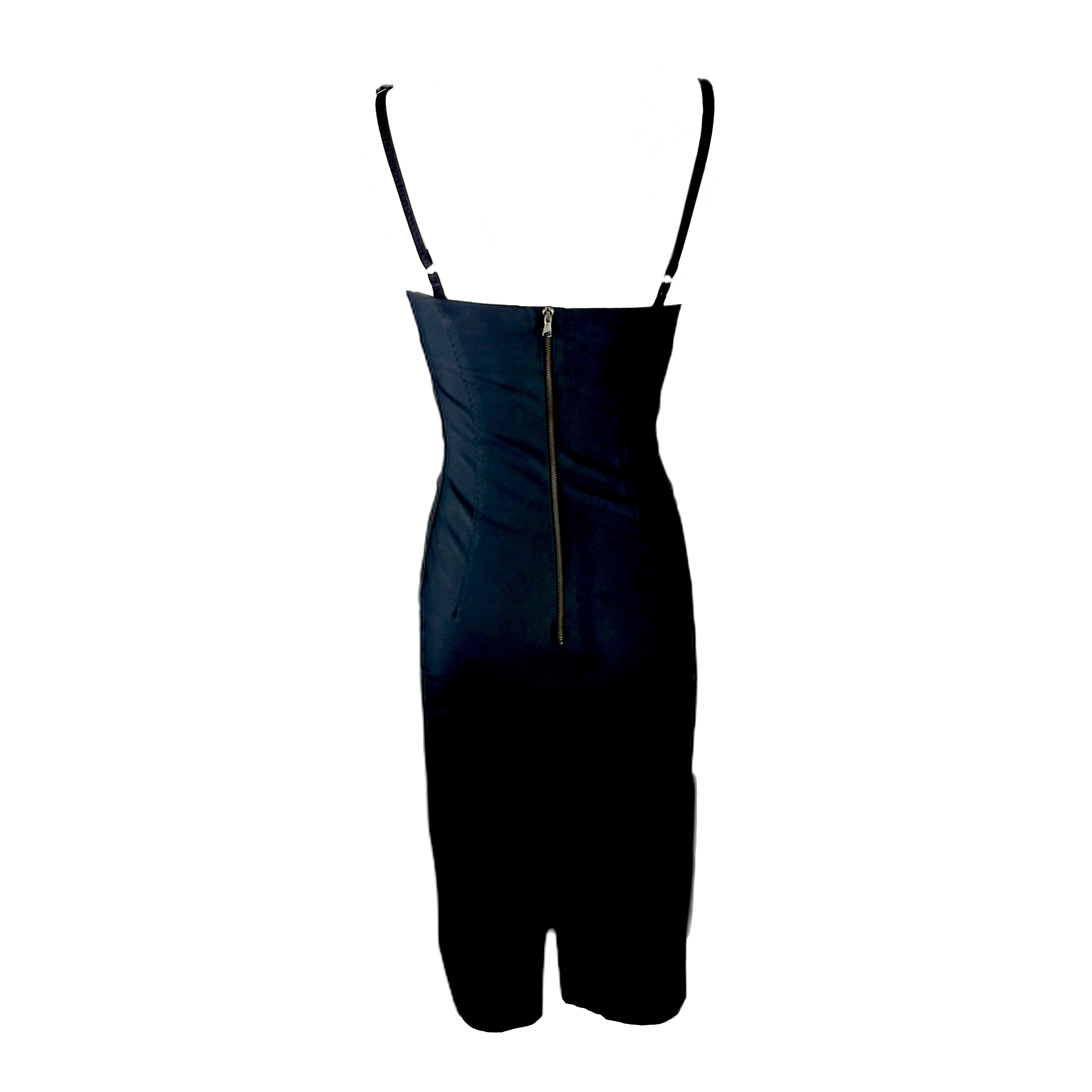 Here is an instant classic by the popular design duo based in Milan, Italy. It is a slip dress with a straight neckline, featuring horizontal pleats on the front side and a rear zip closure. The dress is made of silk stretch fabric and is fully