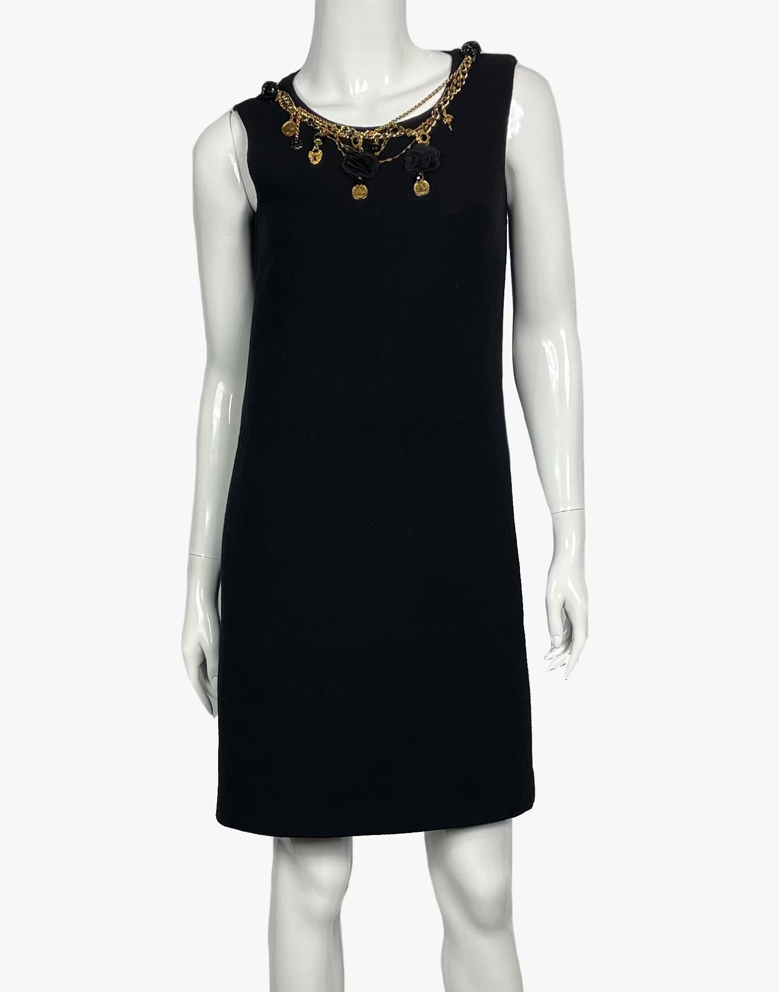 Black mini dress by Dolce Gabbana decorated with golden chains and medallions. Straight cut, sleeveless.  
Period: 2010s
Size - IT 36
Composition: 77% virgin wool, 19% polyamide, 4% lycra

........Additional information ........

- Photo might be