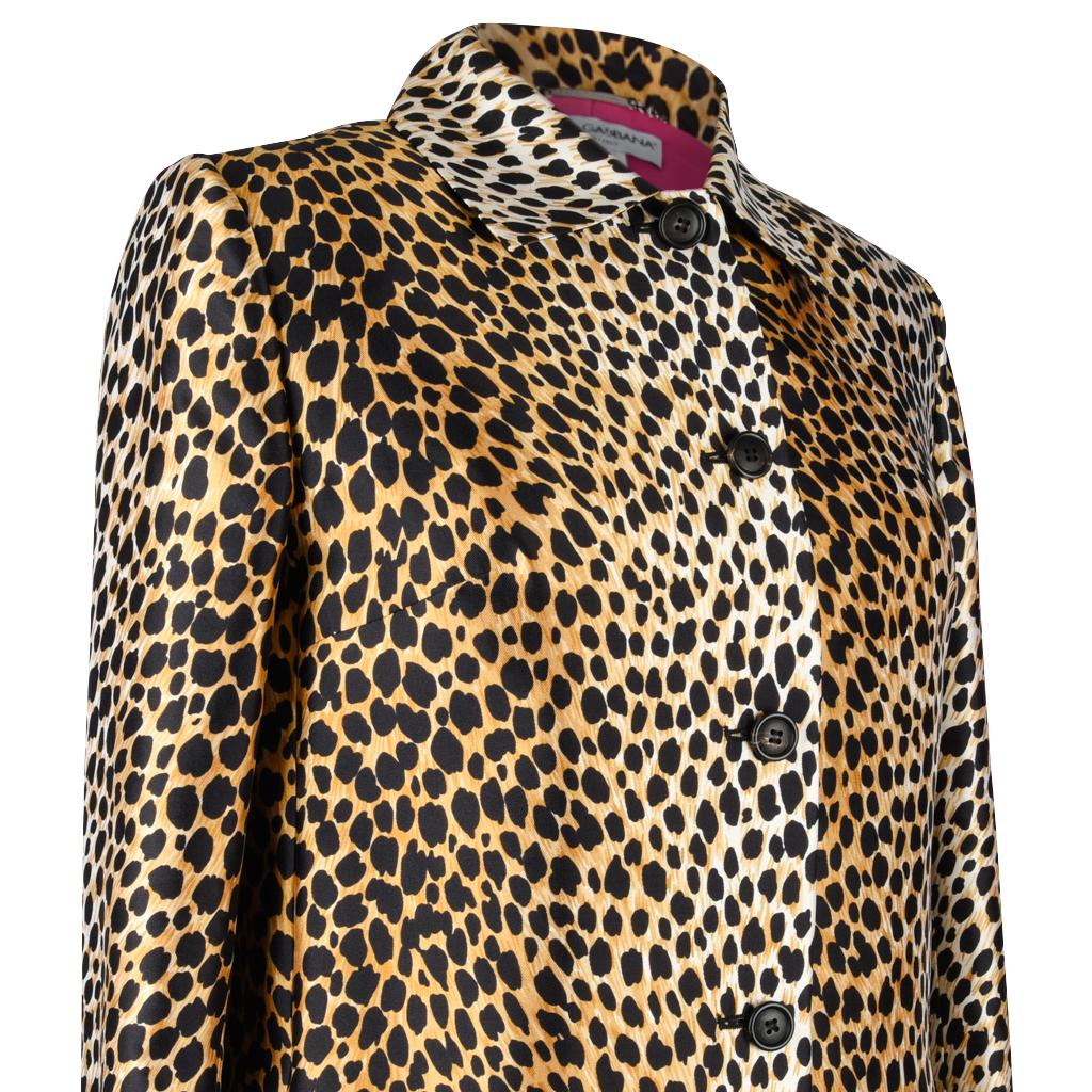 Guaranteed authentic Dolce&Gabbana knee length cheetah print spring coat. 
Easily moves day to evening. 
Slight A-line single breast with 5 black buttons.
2 side slash pockets.
Knee length narrow classic cut.
Coat is lined in vivid pink silk.
Fabric