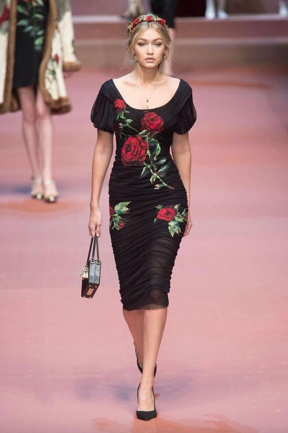 The most wanted black midi dress with red rose embroidery from Dolce&Gabbana F/W 2015 collection. Celebrity favorite, seen on Gigi Hadid, Emily Ratajkowski, Madeleine Stowe, Tina Arena and many others. Showcasing the line's family-focused