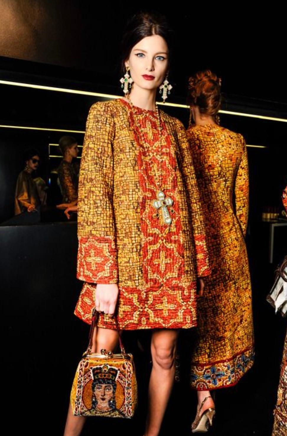 The Dolce & Gabbana Fall/Winter 2013 Byzantine mosaic dress is a stunning piece from the iconic collection inspired by the mesmerizing mosaics of the Monreale Cathedral in Sicily. This lovely mini dress is crafted from a luxurious silk and wool