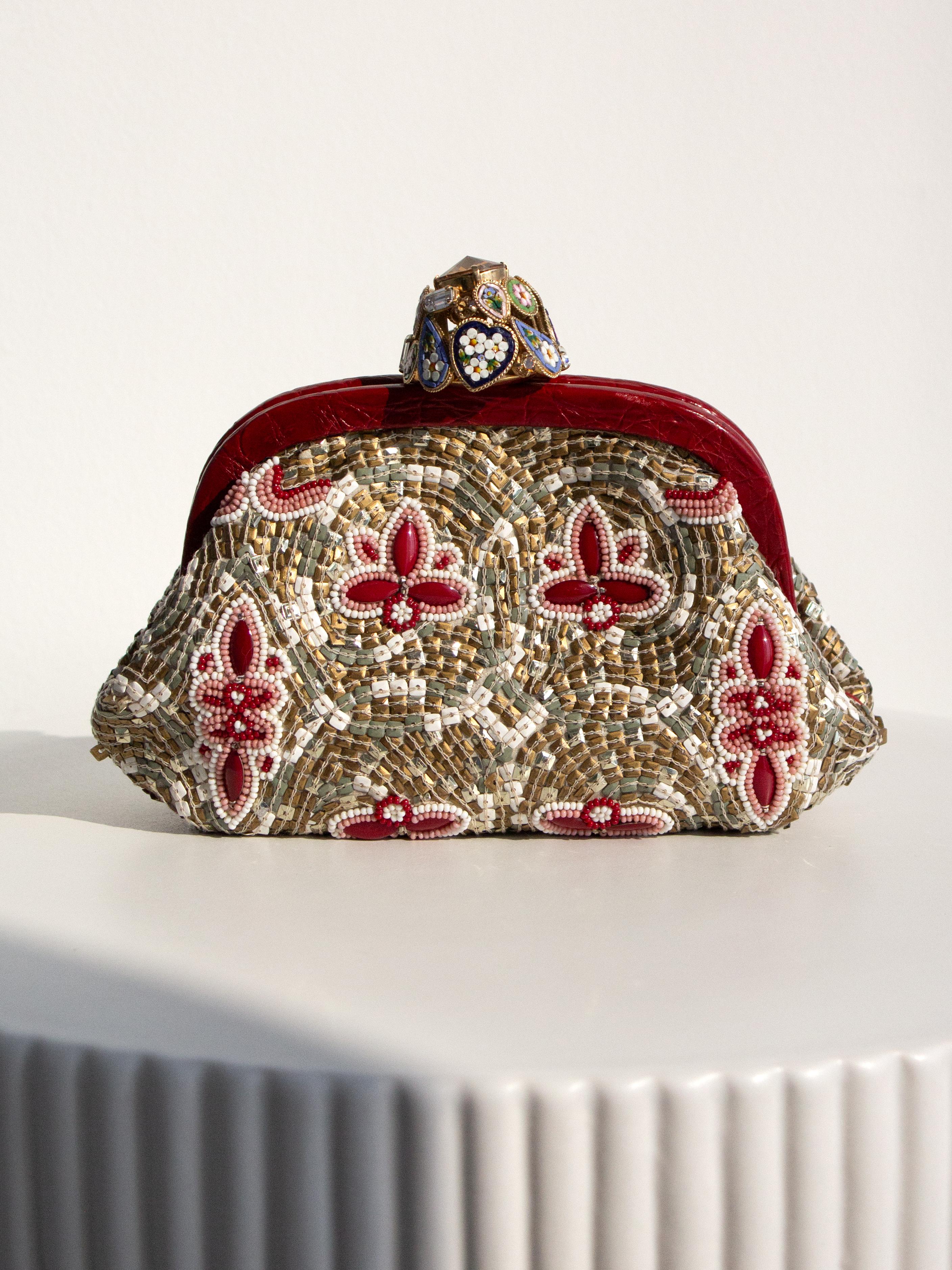 The Dolce&Gabbana Fall/Winter 2013 Miss Dea clutch bag draws inspiration from Sicily's Monreale Cathedral mosaics. Crafted from genuine caiman crocodile leather, it features a vibrant mosaic pattern created with sequins and crystals. Complete with a