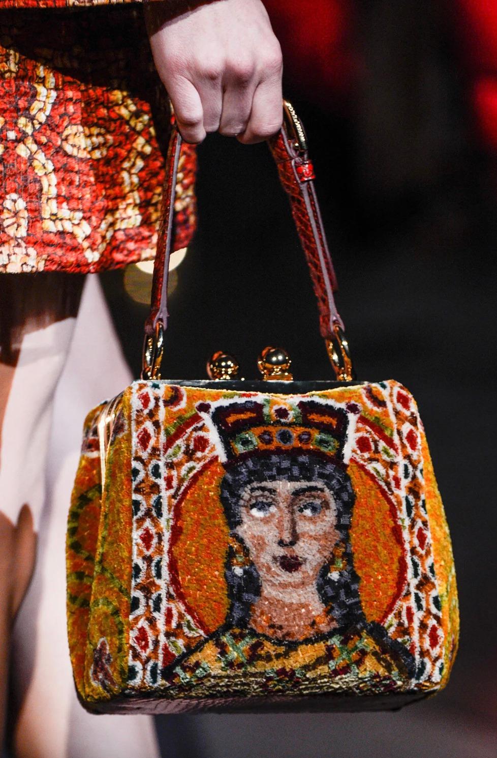 The Dolce&Gabbana Fall/Winter 2013 Queen Regina bag is a luxurious masterpiece, drawing inspiration from the enchanting mosaics of Sicily's Monreale Cathedral. This limited edition gem combines gold hardware, red python leather bottom and stra[, and