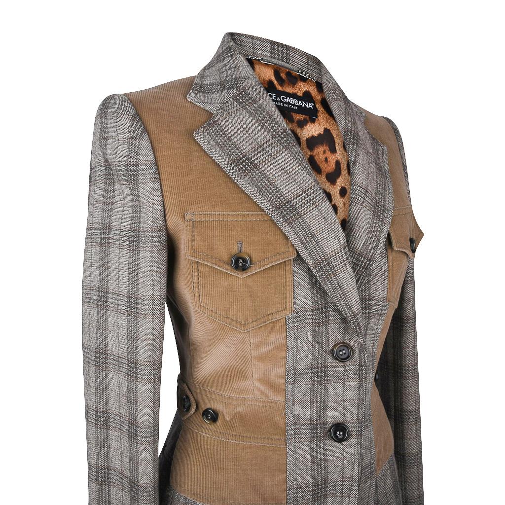 Guaranteed authentic Dolce&Gabbana single breast grey tweed/plaid jacket. 
Fabulous tan corduroy trim with design elements give the effect of a vest.
2 breast button down flap pockets.
2 button down flap pockets at sides.
Has 4 working buttons on