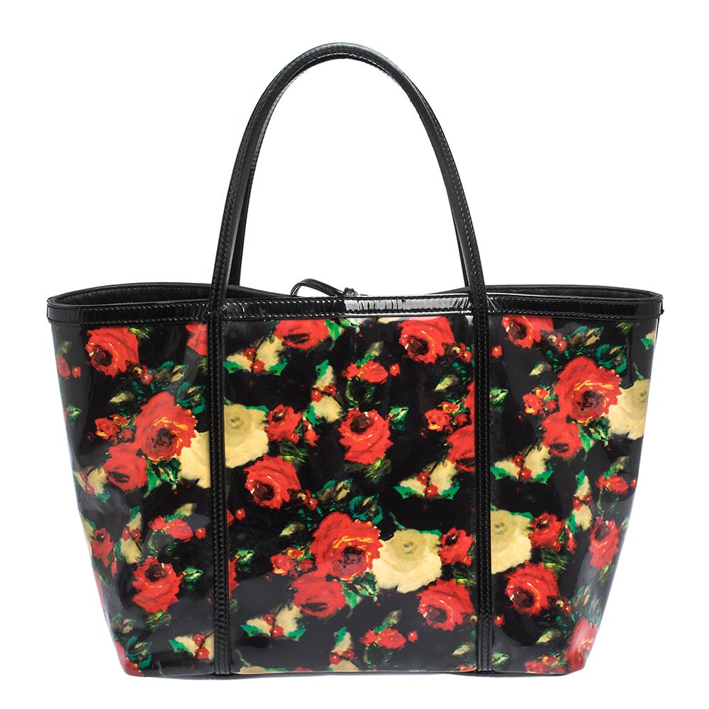 This stunning tote is from the house of Dolce & Gabbana. Crafted from vinyl and patent leather, and lined with canvas on the insides, the multicoloured floral bag features dual top handles and a gold-tone logo plaque flaunted on the front. Swing it
