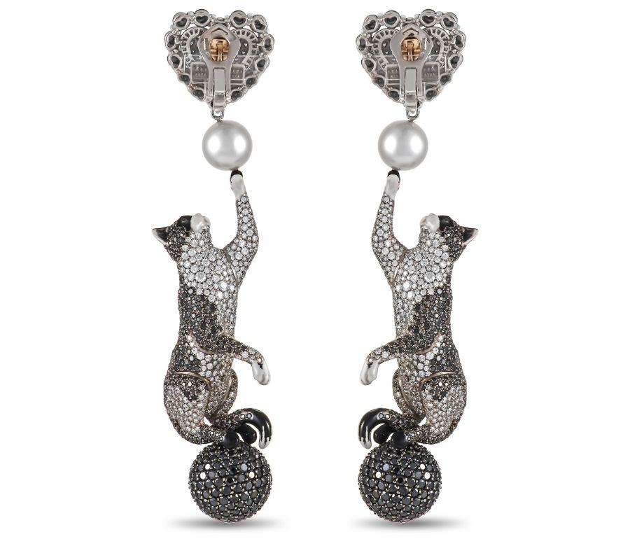These 18K White Gold Dolce & Gabbana Domenico Camerati Panthere earrings are as charming as they are chic. Each one of these elegant earrings measures 3.5” long, 1” wide, and features a playful cat motif. Opulent pearl accents and a stunning array