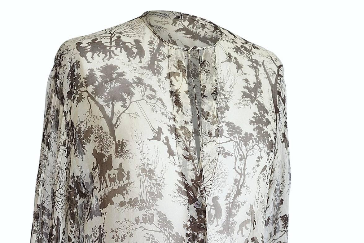 Beautiful Dolce & Gabbana semi sheer and ultra light silk top. 
Charming and idyllic print in cream and brown.
Deep V with 2 ties and 6 embossed buttons.
Gently ruffled cuffs.
No fabric or size tag - fabric is silk chiffon.
final sale

SIZE 40
USA
