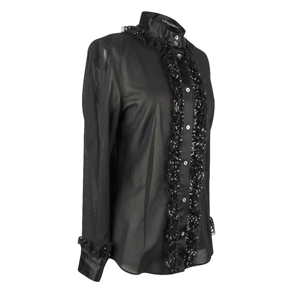 Guaranteed authentic  Dolce&Gabbana ssignature shaped black blouse with beautiful detail!
Jet black semi sheer long sleeve button down top. 
Mandarin collar with beautiful lace ruffle covered with teeny black paillettes that continue down the front