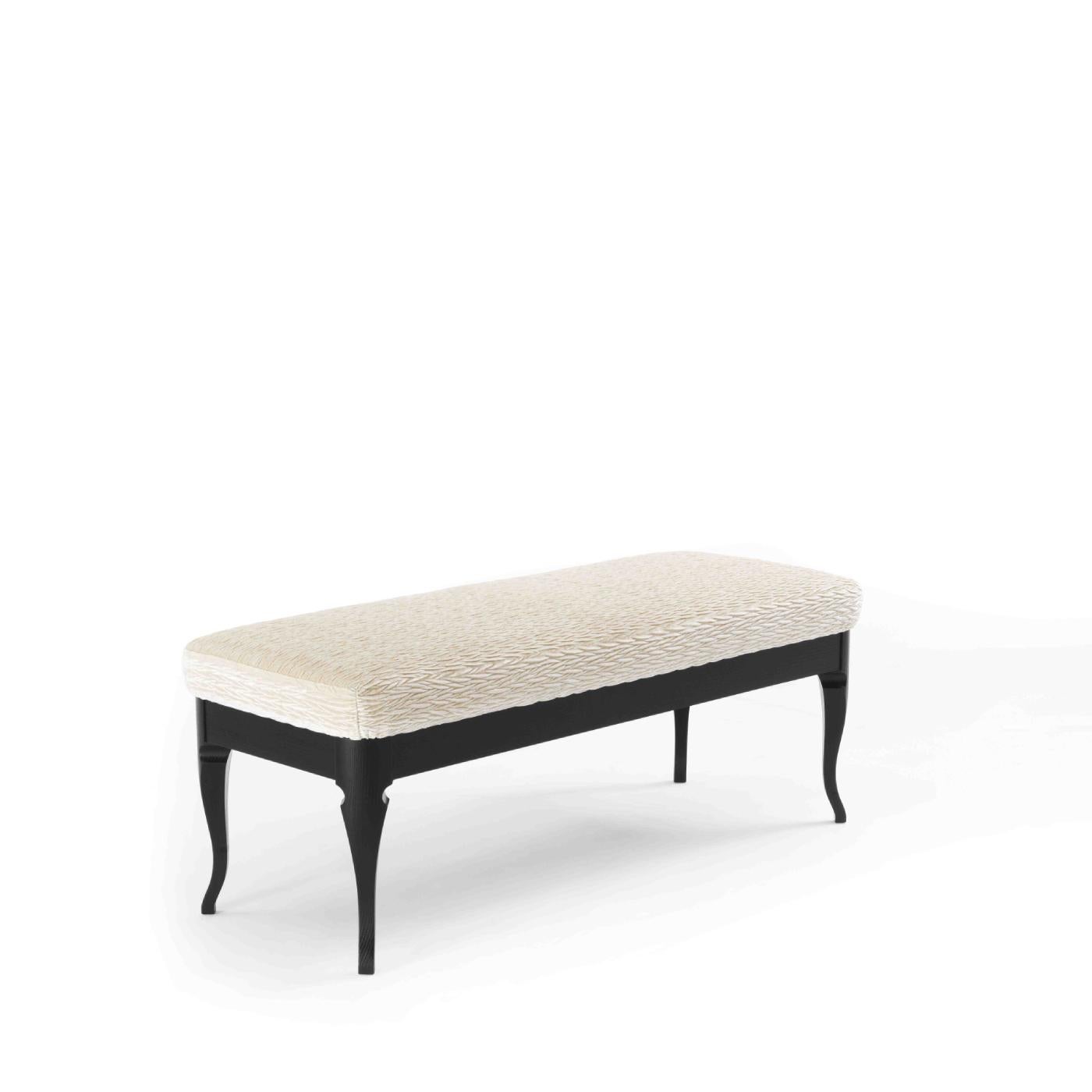 With its unique style that combines retro-inspiration with a modern aesthetic, this bench offers a functional accent in a modern and mid-century interior. The solid ash frame is embellished with a dark, ebonized finish that complements the