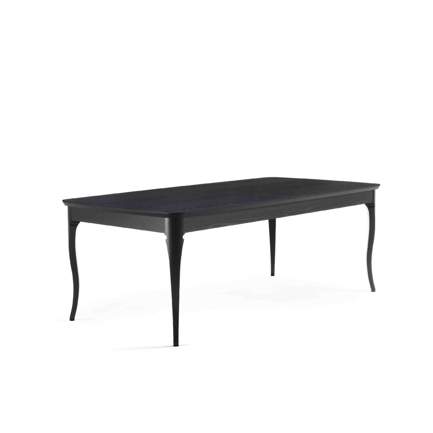 A harmonious balance of sculptural aesthetic and functionality, this dining table is handcrafted of wood with an ash veneer and ebonized finish and boasts a rectangular top raised on a base of cabriole-style legs inserted in the solid wood recessed