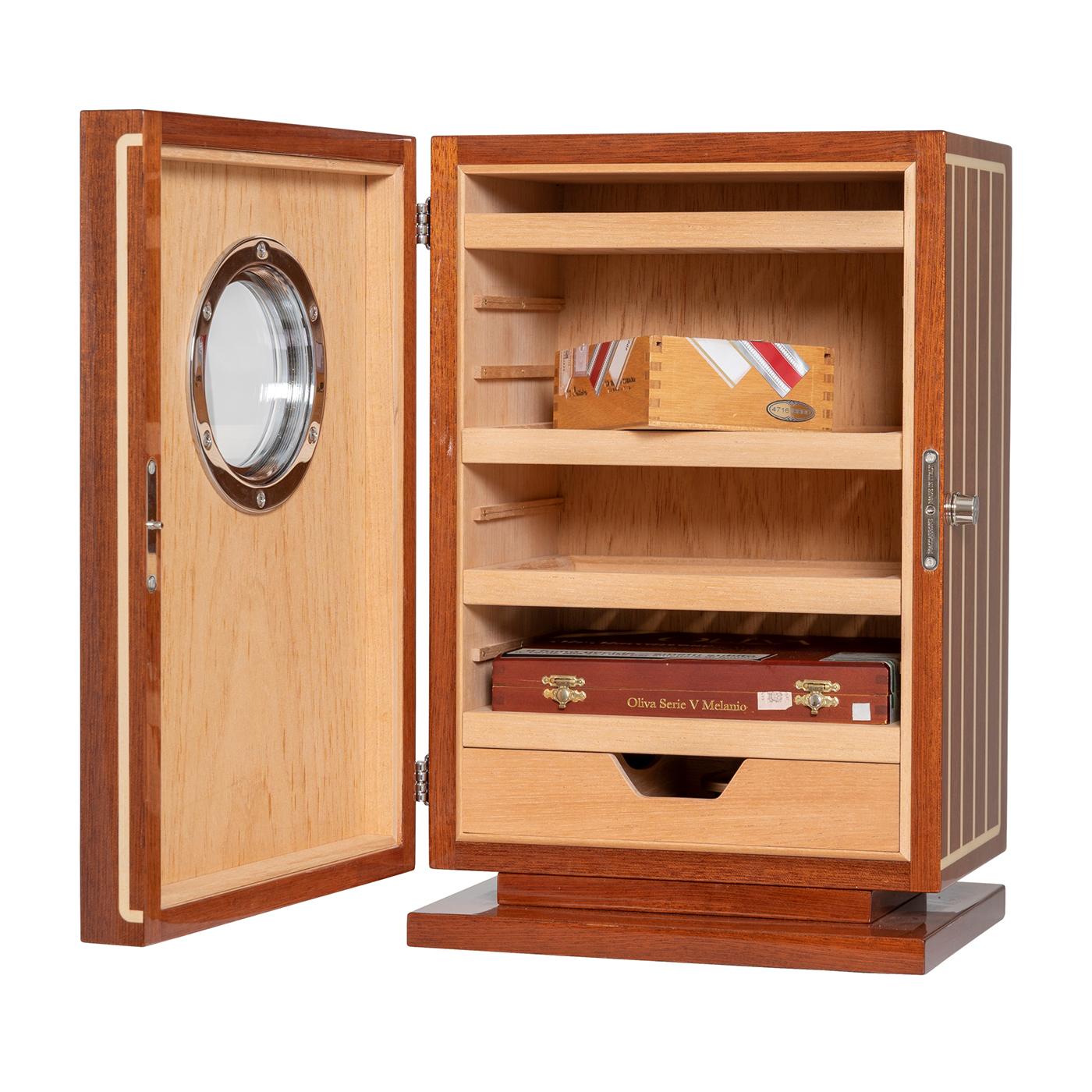 This iconic humidor is part of Maccarone's Yacht collection and can hold up to 150 cigars. Metal accessories in chromed brass and high gloss mahogany and maple inlay enhance this elegant and refined humidor designed for yacht and cigar enthusiasts.