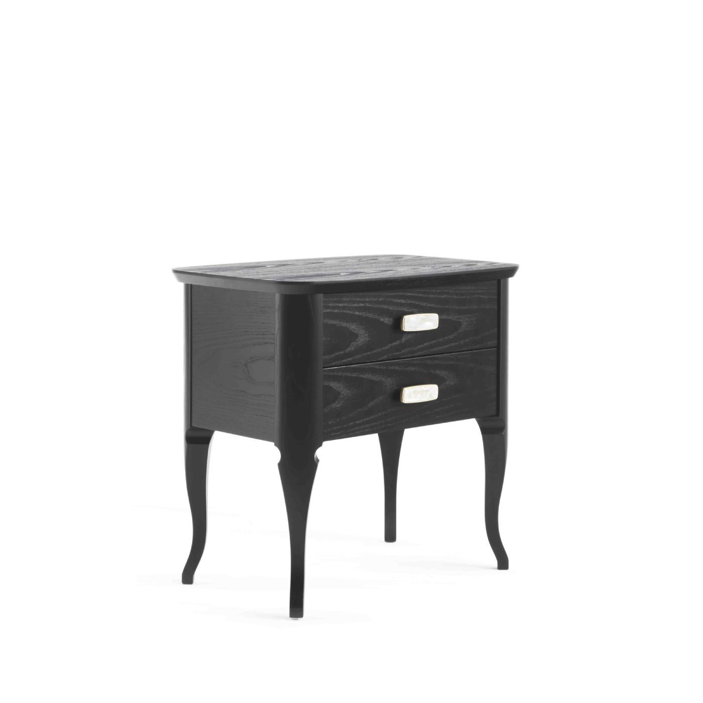 Combining the essential lines of mid-century design with exquisite craftsmanship, this nightstand is the perfect addition to a modern bedroom decor. The rectangular construction in ash-veneered wood stands on four cabriole legs features two drawers