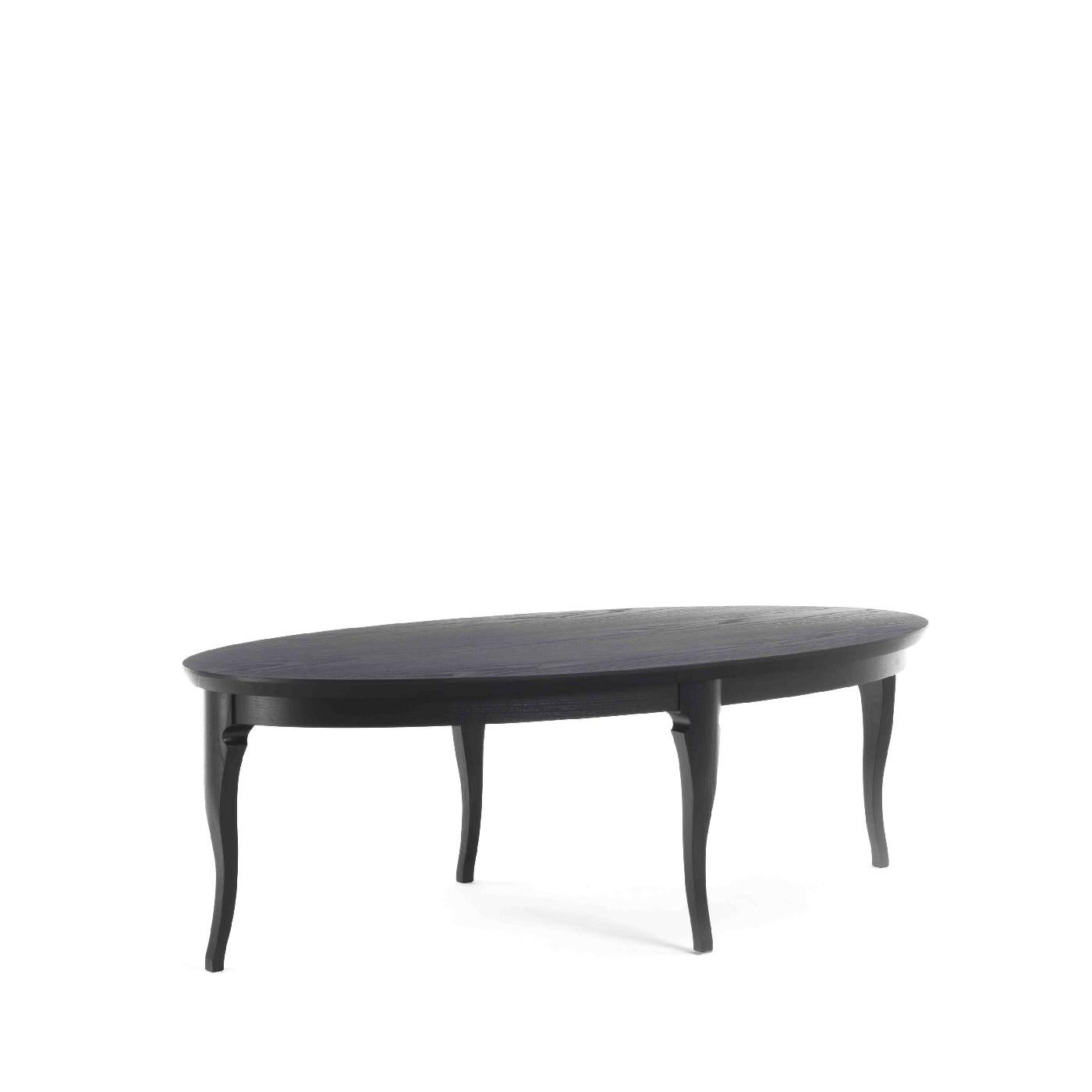 Defined by formal simplicity and midcentury inspiration, this coffee table combines elegance with functionality. Entirely handcrafted of wood with ash veneer and an ebonized finish, the piece has an oval top raised on cabriole legs placed at the