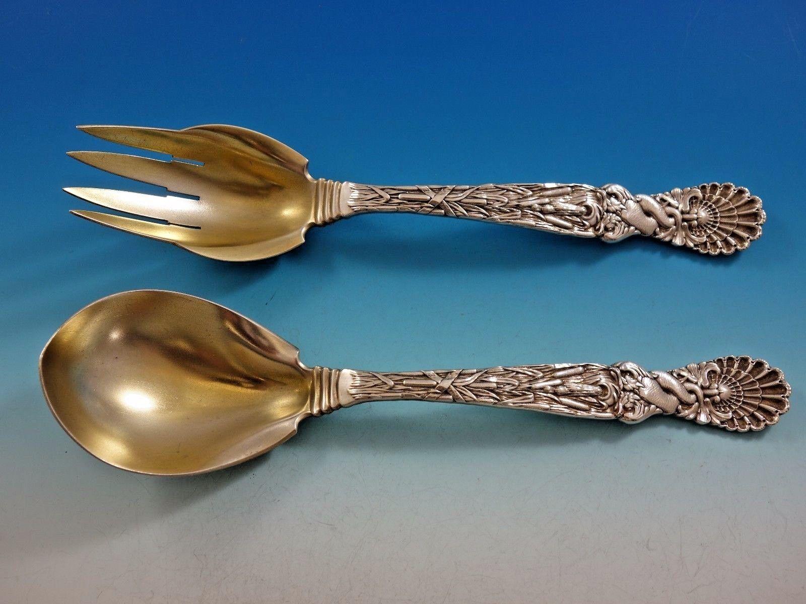 Outstanding sterling silver salad serving set three-piece in the pattern Dolphin by Tiffany and Co. 
This rare set includes:

1- Salad bowl: Featuring stylized dolphins and seashells. The piece is footed, it's marked with #7096/6137, and has a