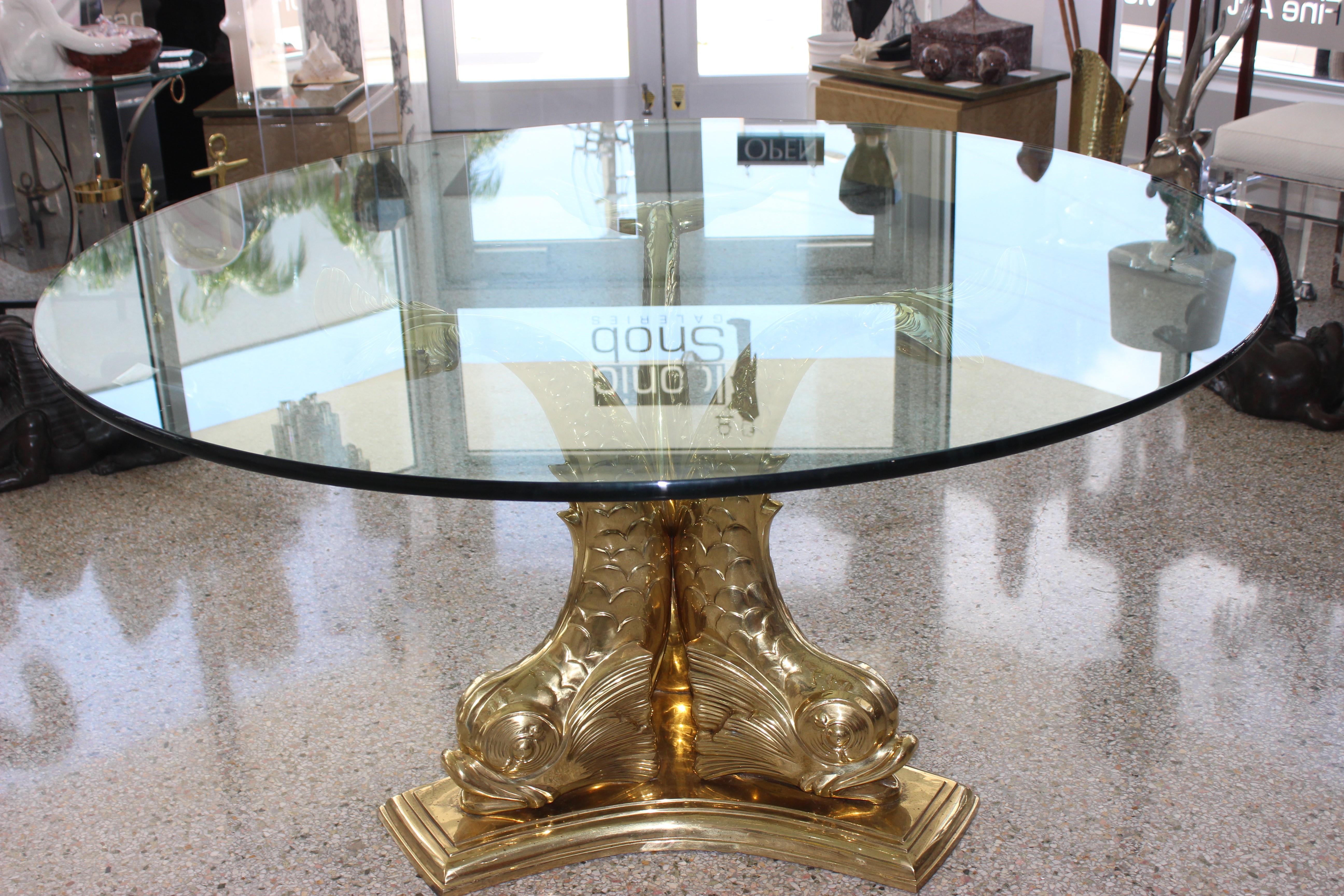 Fabulous dolphin dining or center table with polished brass base and 60