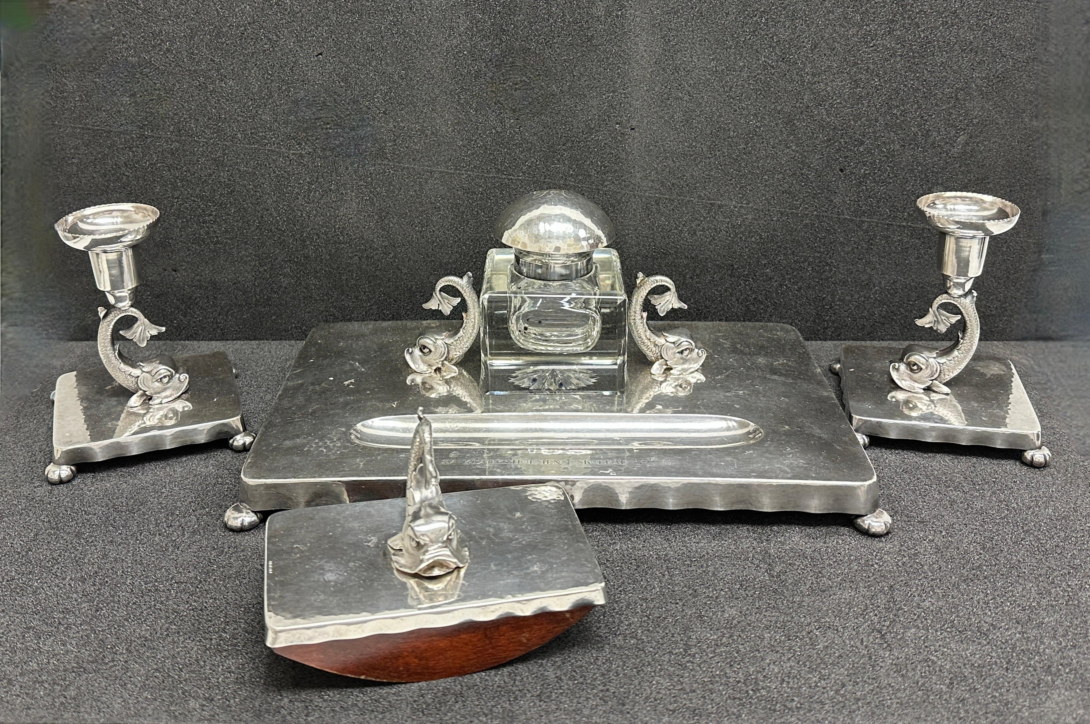 Classic 1930s dolphin fish desktop accessories inkwell, blotter and candlestick set. Made of silver plated metal and crystal glass. Nice addition to your writing desk or just to display them in your room. Found at an estate sale in Stockholm Sweden.