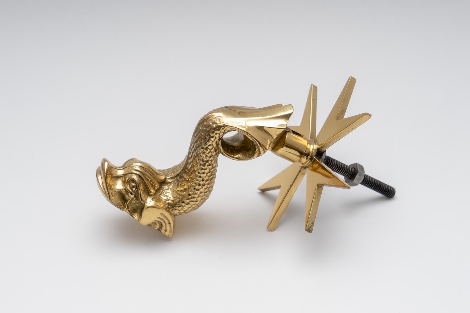 This stylish door knocker is from Malta and is detailed with the Maltese Cross and an upturned dolphin. The piece has been professionally polished. 

Note: Bolt length is 2.38