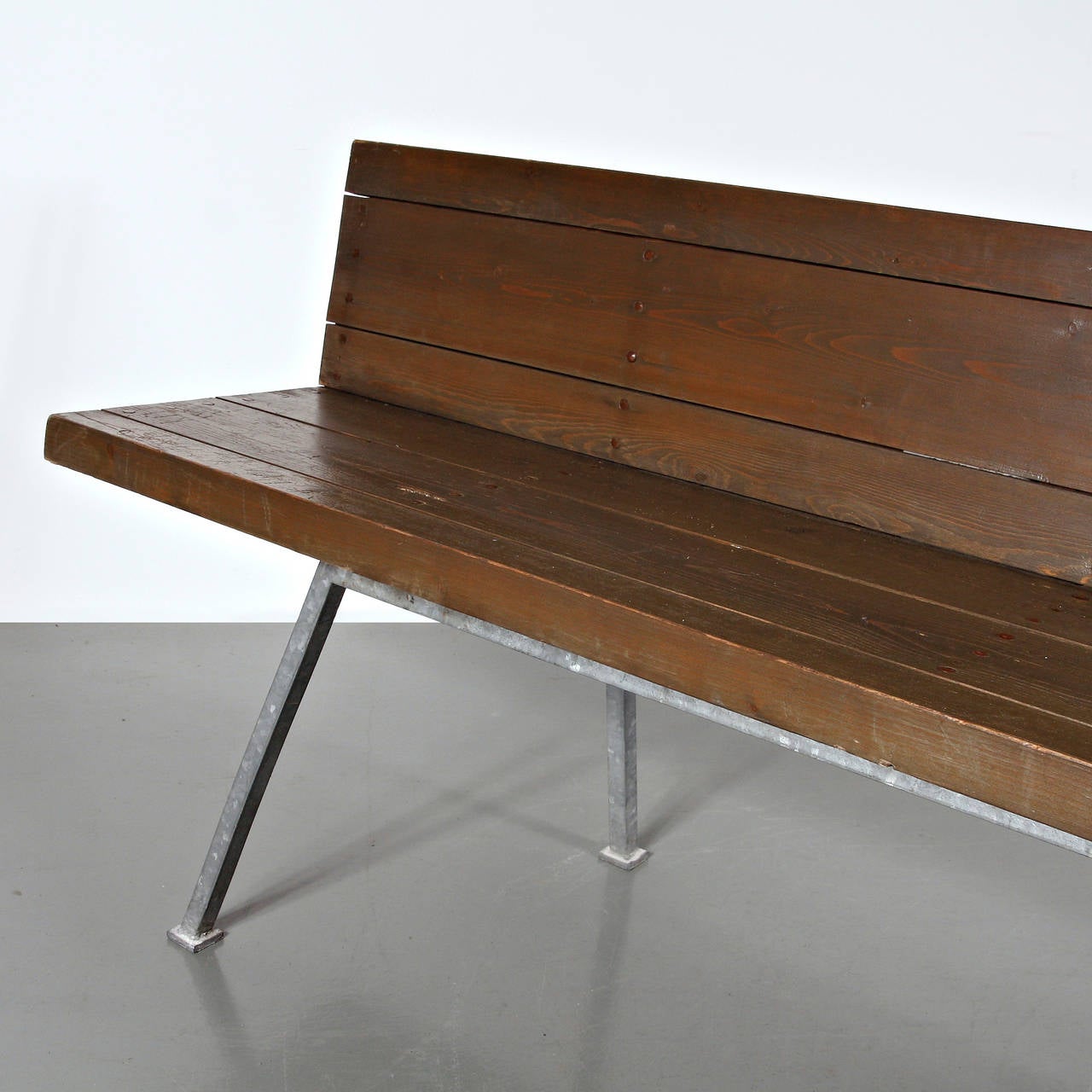 Bench designed by Dom Hans van der Laan for the Abbey Church of St. Benedictusberg, Vaals in the Netherlands in 1967.
Manufactured in the Netherlands in 1967.
Galvanized base and structure, wood seat and backrest with copper nails.

In good