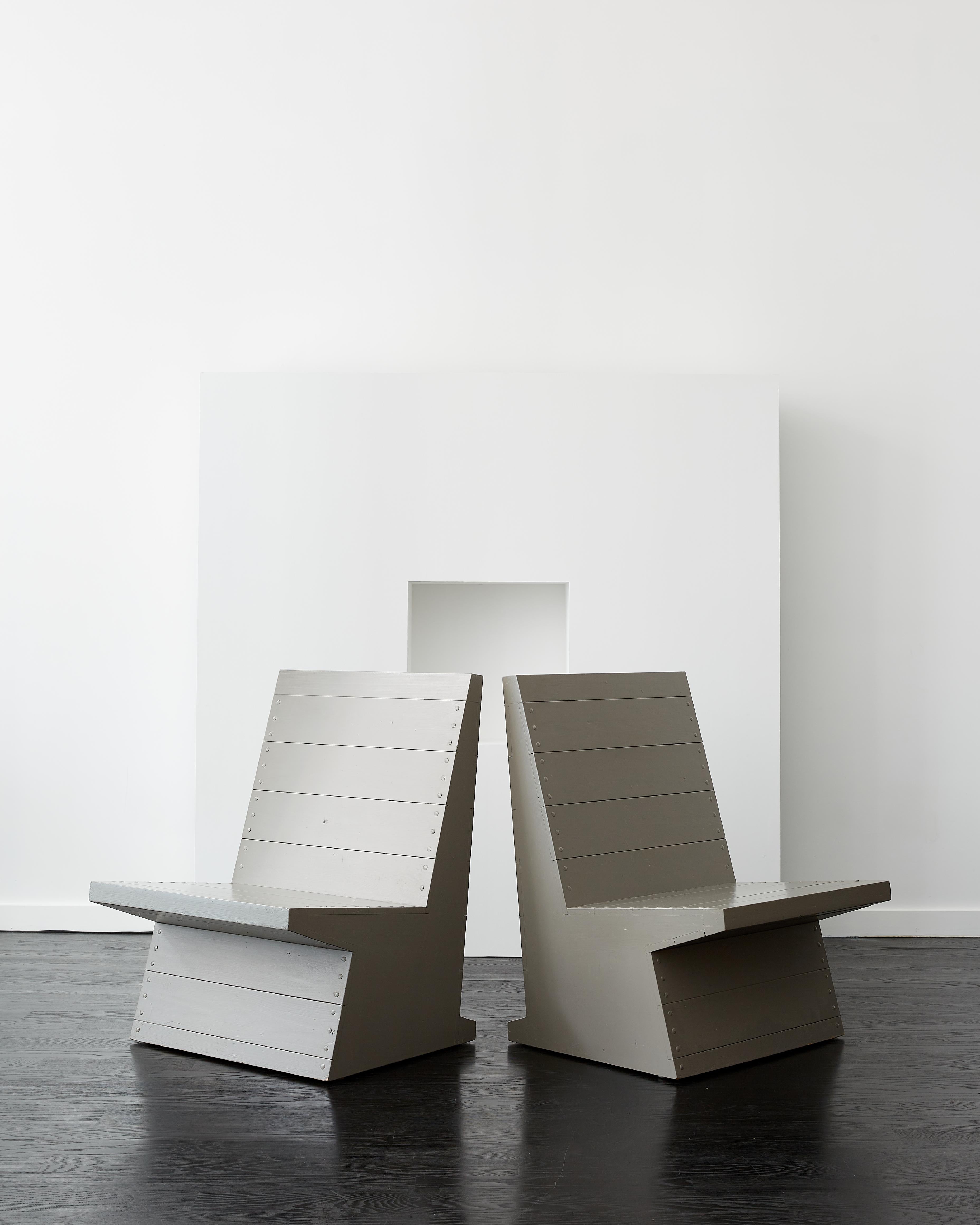 Dom Hans van der Laan pair of low gray chairs.

Executed by Gorisse for a private library.

Bergeijk, the Netherlands c. 1979.

Pine, steel nails, paint. 

Color is F2-05-45 from van Der Laan’s highly selective color palette of eight shades, which