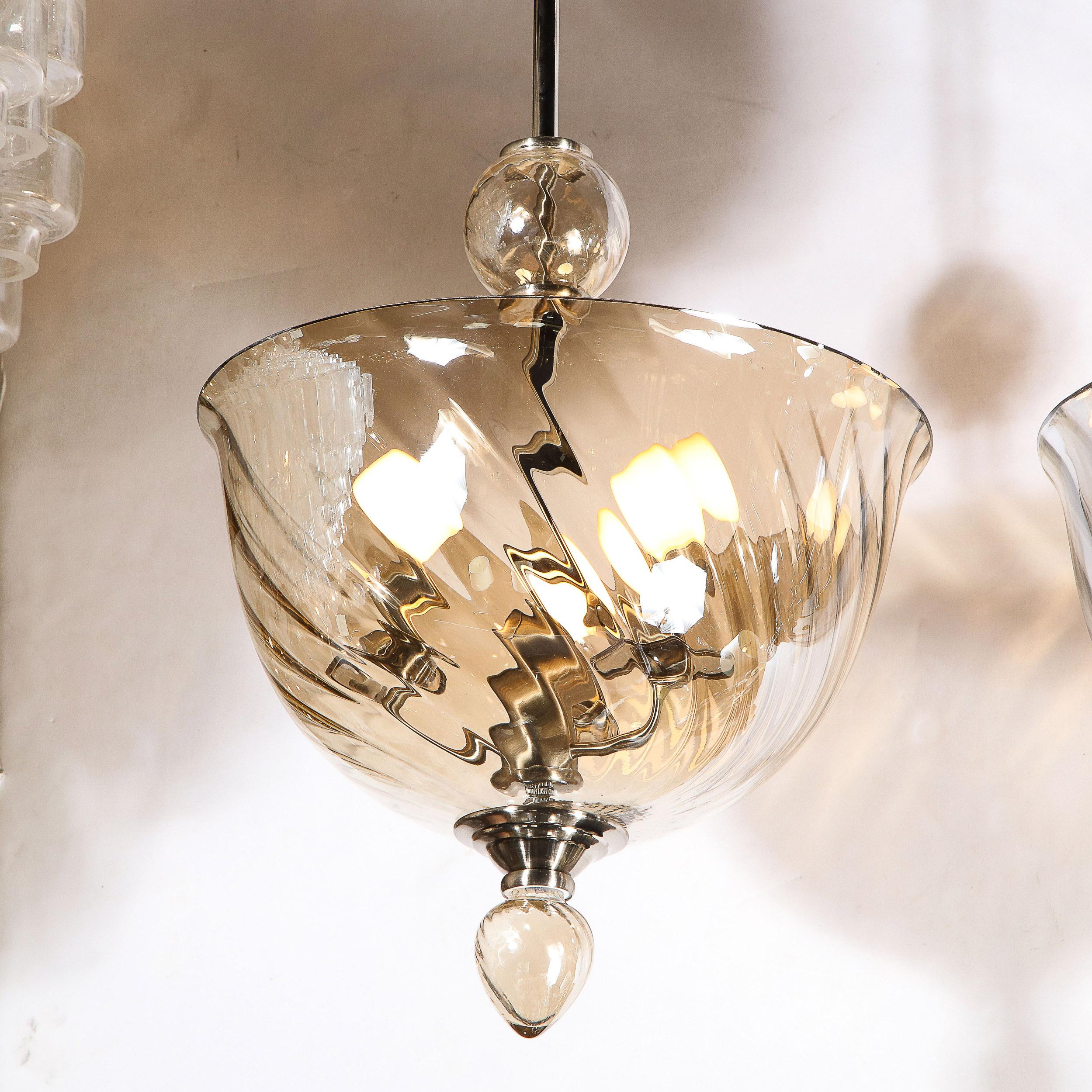An Italian Mid-Century Modernist handblown Murano glass reverse-dome swirled detail glass chandelier. Nickel & Chrome fittings throughout, as well as a droplet glass finial detail complete the piece. The Chrome fitting can be adjusted to suit
