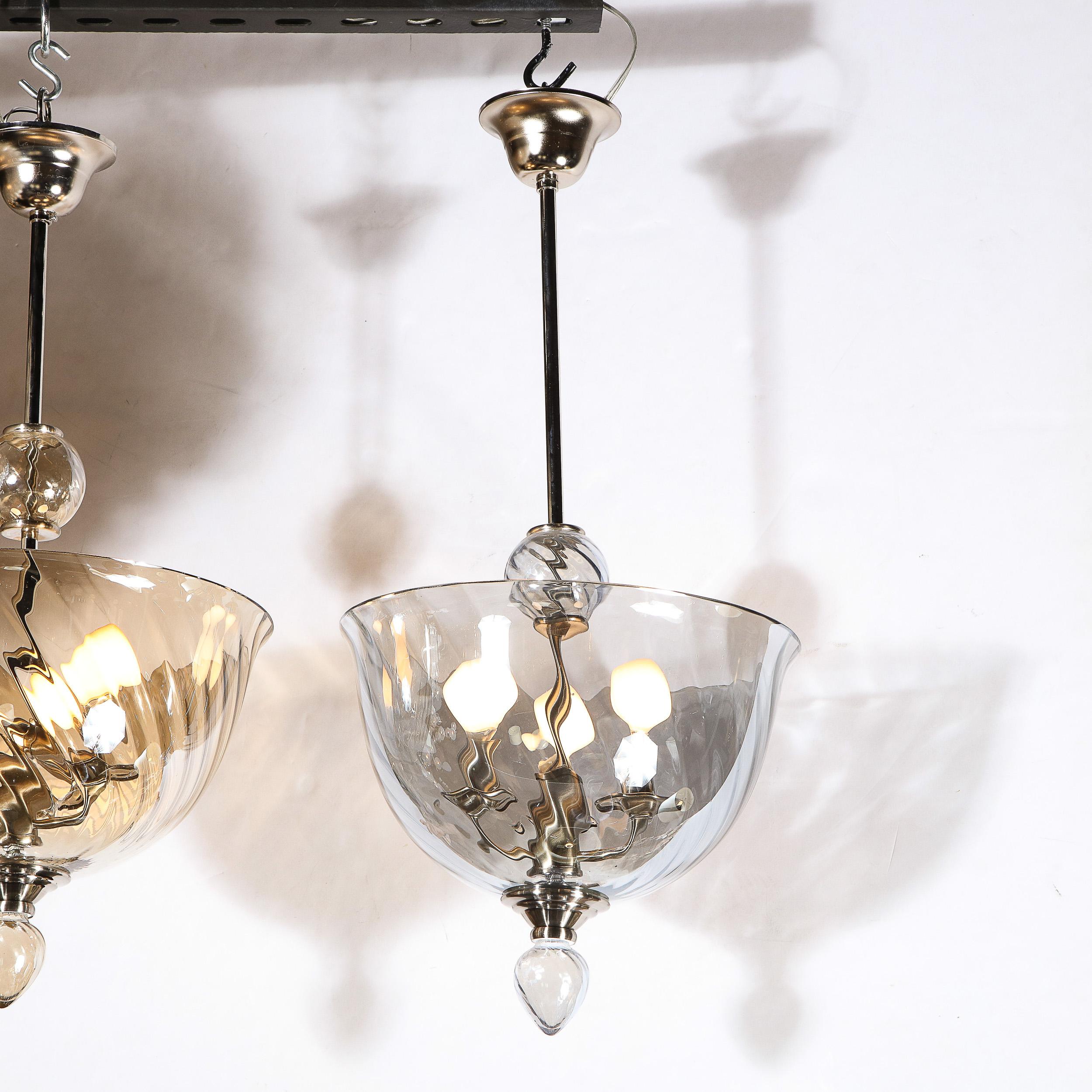 An Italian Mid-Century Modernist handblown Murano glass reverse-dome swirled detail glass chandelier. Nickel & Chrome fittings throughout, as well as a droplet glass finial detail complete the piece. The Chrome fitting can be adjusted to suit