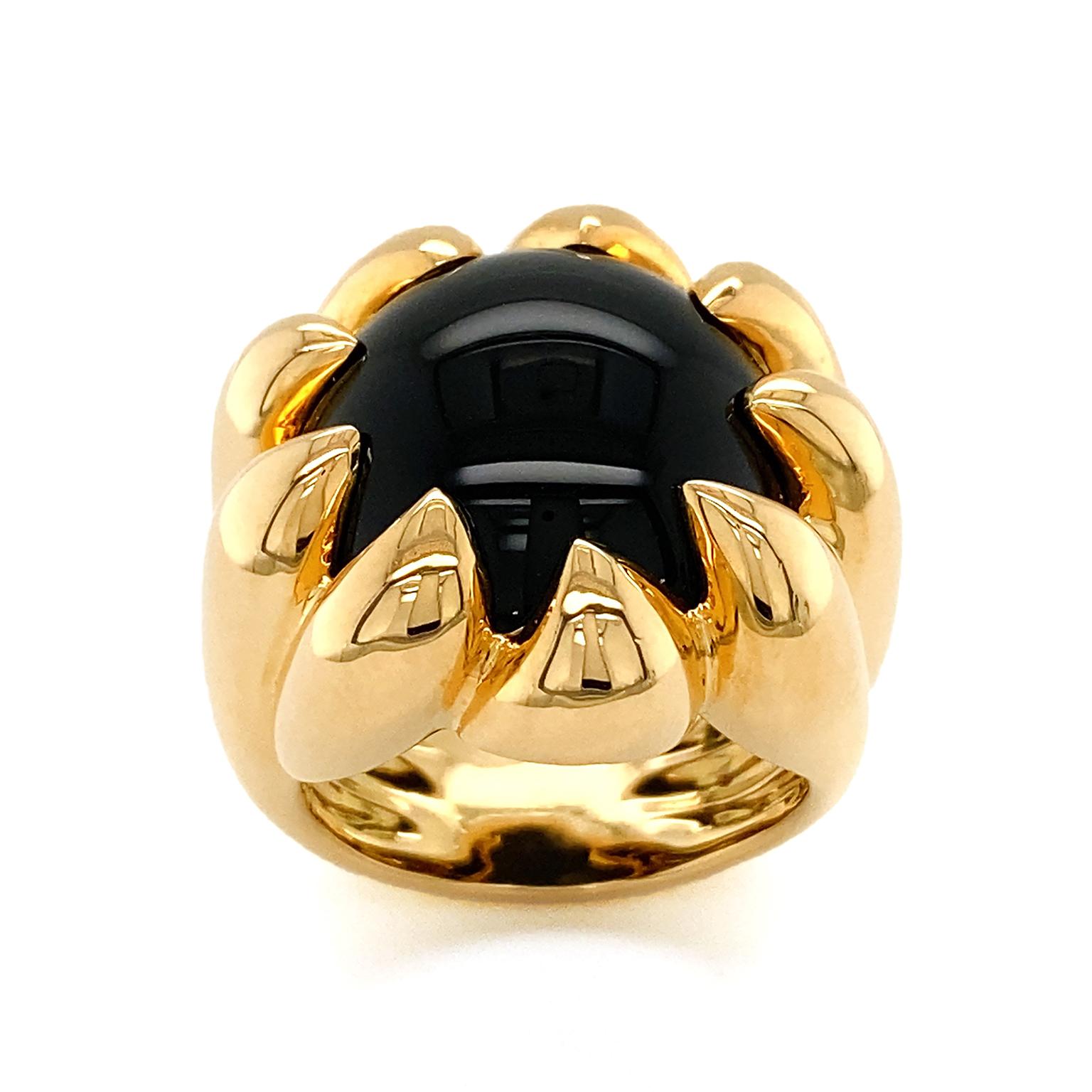 A polished 18k yellow gold band raises to the apex of black onyx. The claw prongs supporting the onyx create striking interest in this gleaming ring. Measurements for the ring are 0.97 inches (width) by 0.91 inches (length) by 1.11 inches (height).
