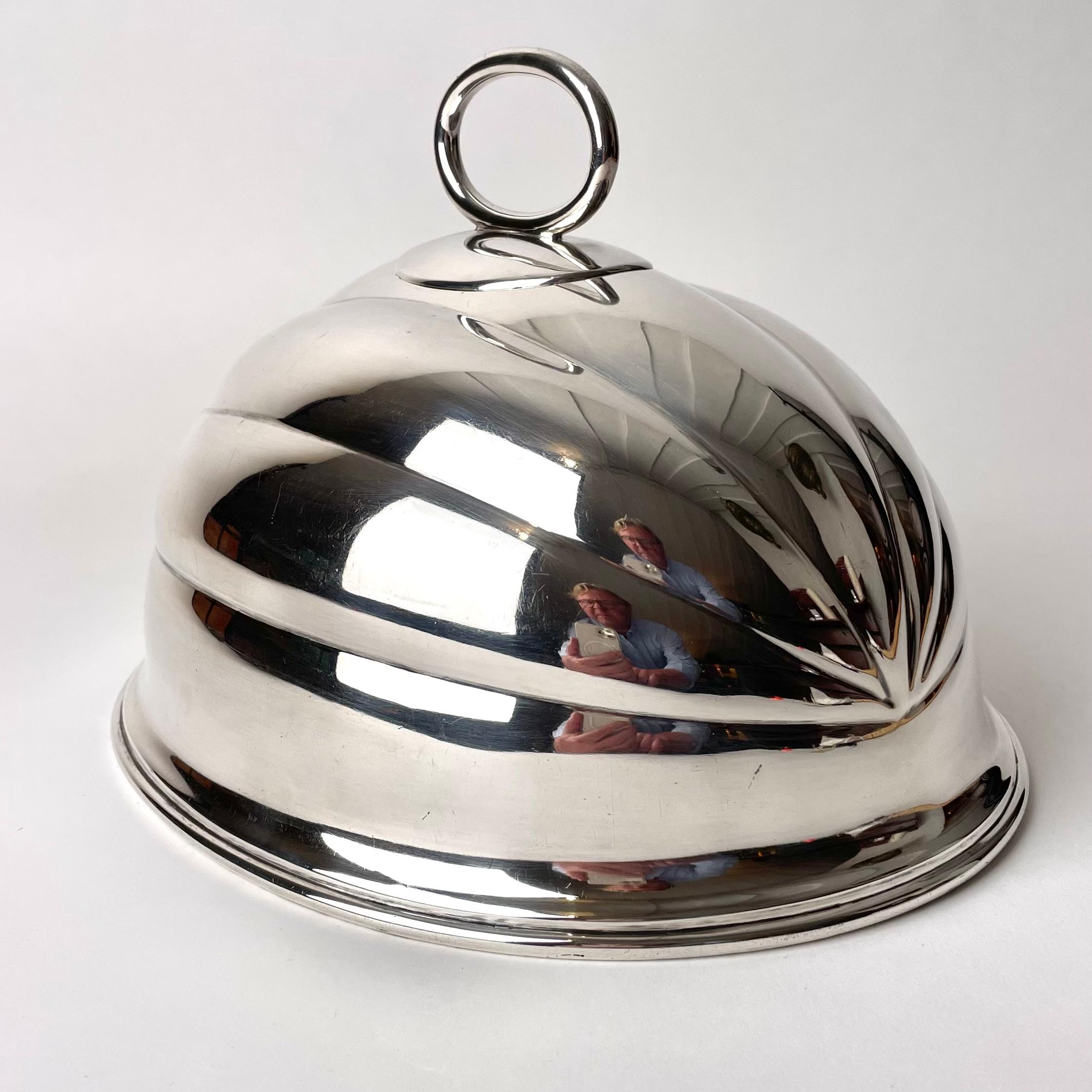 Dome Cover Cloche in Sheffield Plate, Late 19th Century England by Mappin & Webb.

This expertly crafted cloche in Sheffield plate was manufactured by English luxury and silver working company Mappin & Webb. The company has long held Royal Warrants,