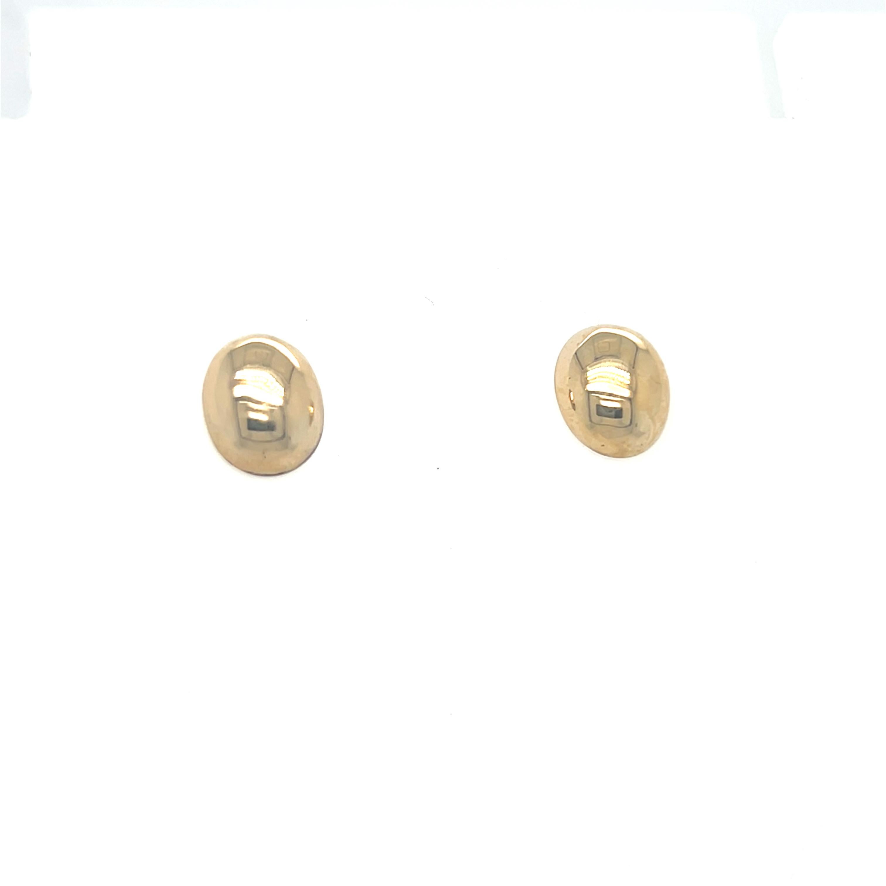 These stylish gold dome puffy oval stud earrings feature a sleek design, measuring 9.8 x 8.2 mm, and are crafted from 14k yellow gold. Their smooth, rounded shape adds a touch of modern elegance, making them a versatile accessory that effortlessly