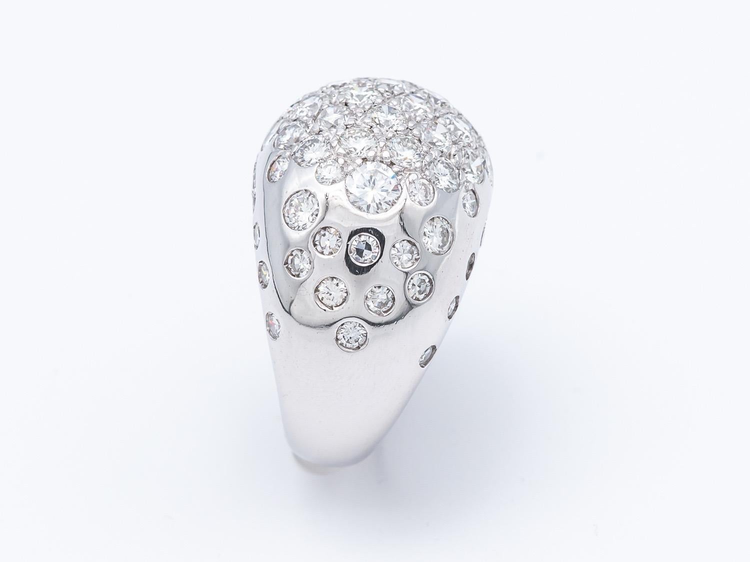 Behold the magnificent Dome Ring, a true marvel of elegance and luxury, meticulously crafted in 18K gold and adorned with a resplendent array of 54 brilliant cut diamonds. This opulent piece boasts a voluminous design, making it a striking statement