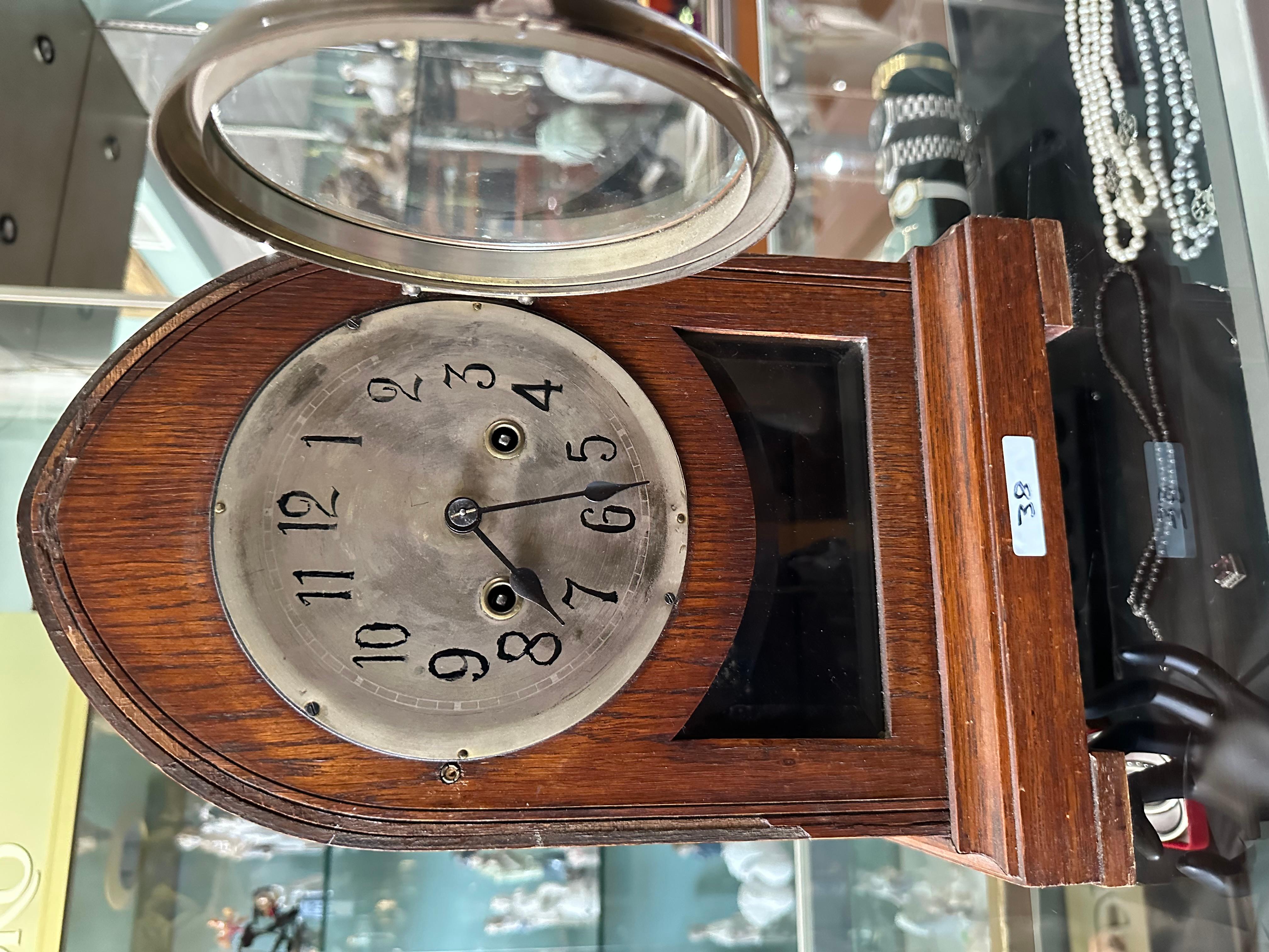 Antique dome style clock from the 20th century 

notable damage to the front veneer of the glass 