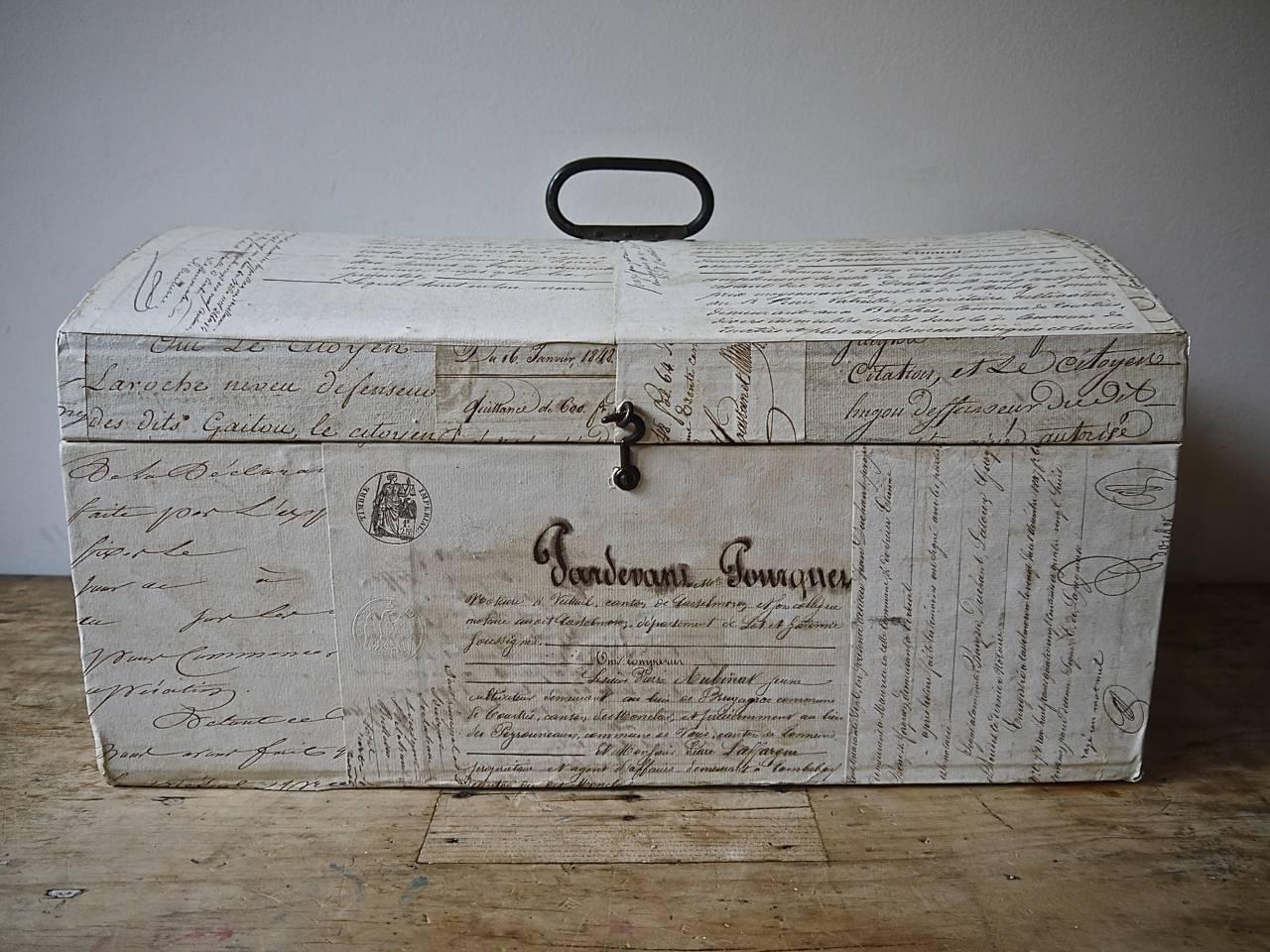 19th century French domed box with its original handle customised on the outside and inside with a variety of old manuscripts and documents.
    