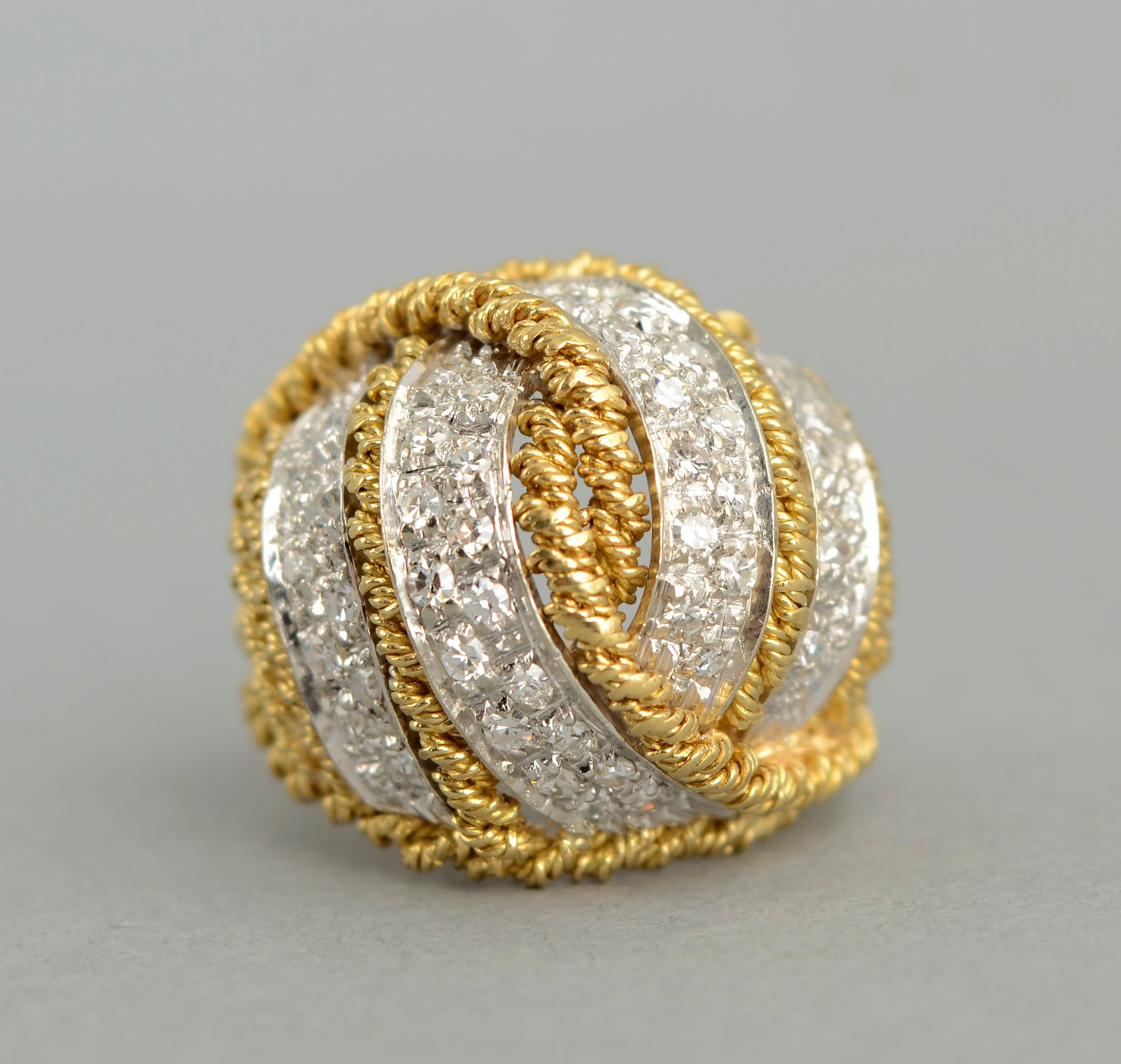 Elegant  domed cocktail ring with diamonds and a design of intertwined twisted 18 karat gold banding. The ring has a total diamond weight of approximately 1.2 carats; stones are SI 1. The ring is size 6 1/4. The dome is 5/8