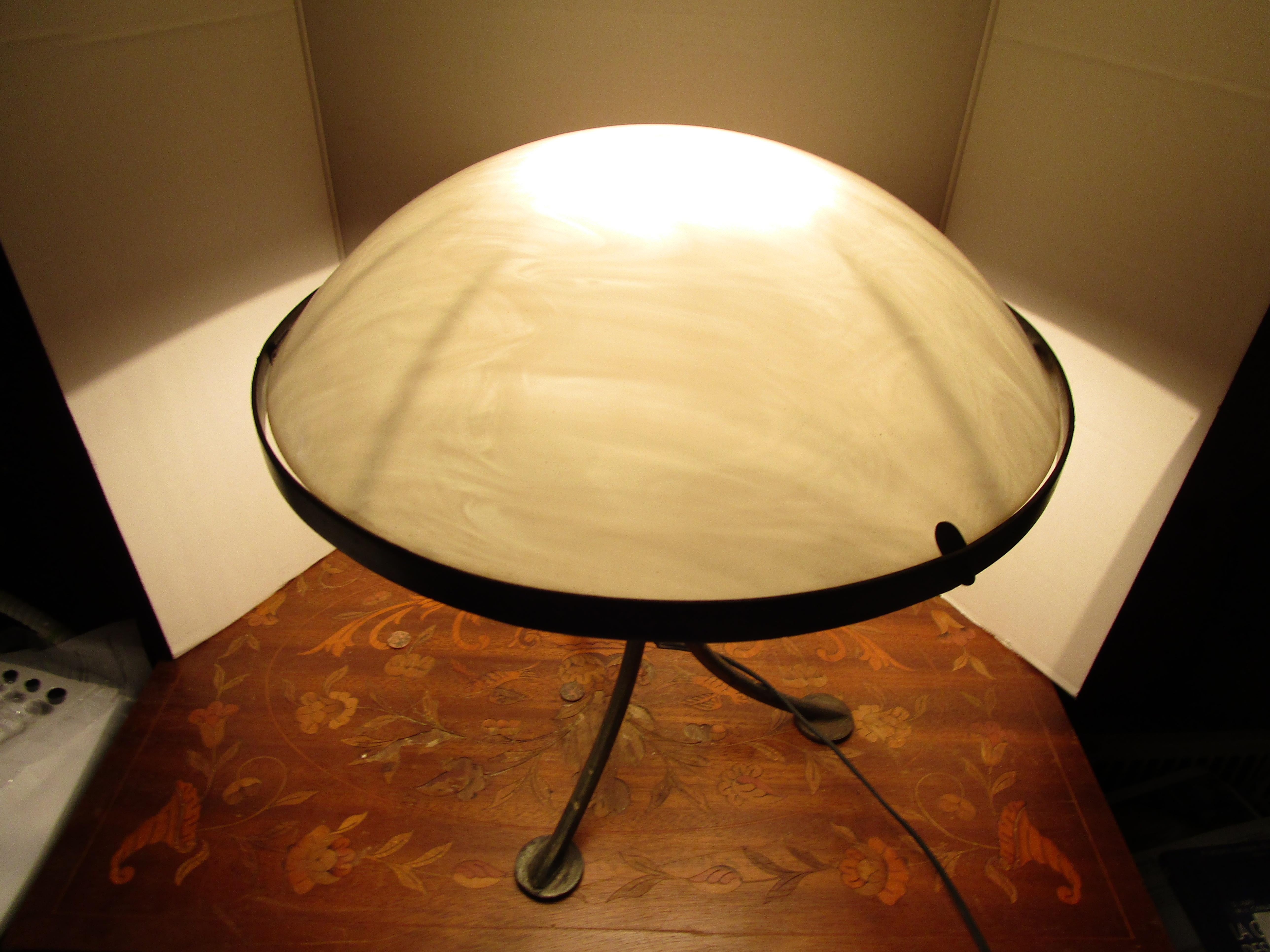 The opaline glass dome gives this lamp the best futuristic feel as well as the tripod feet that suggest some sort of 
