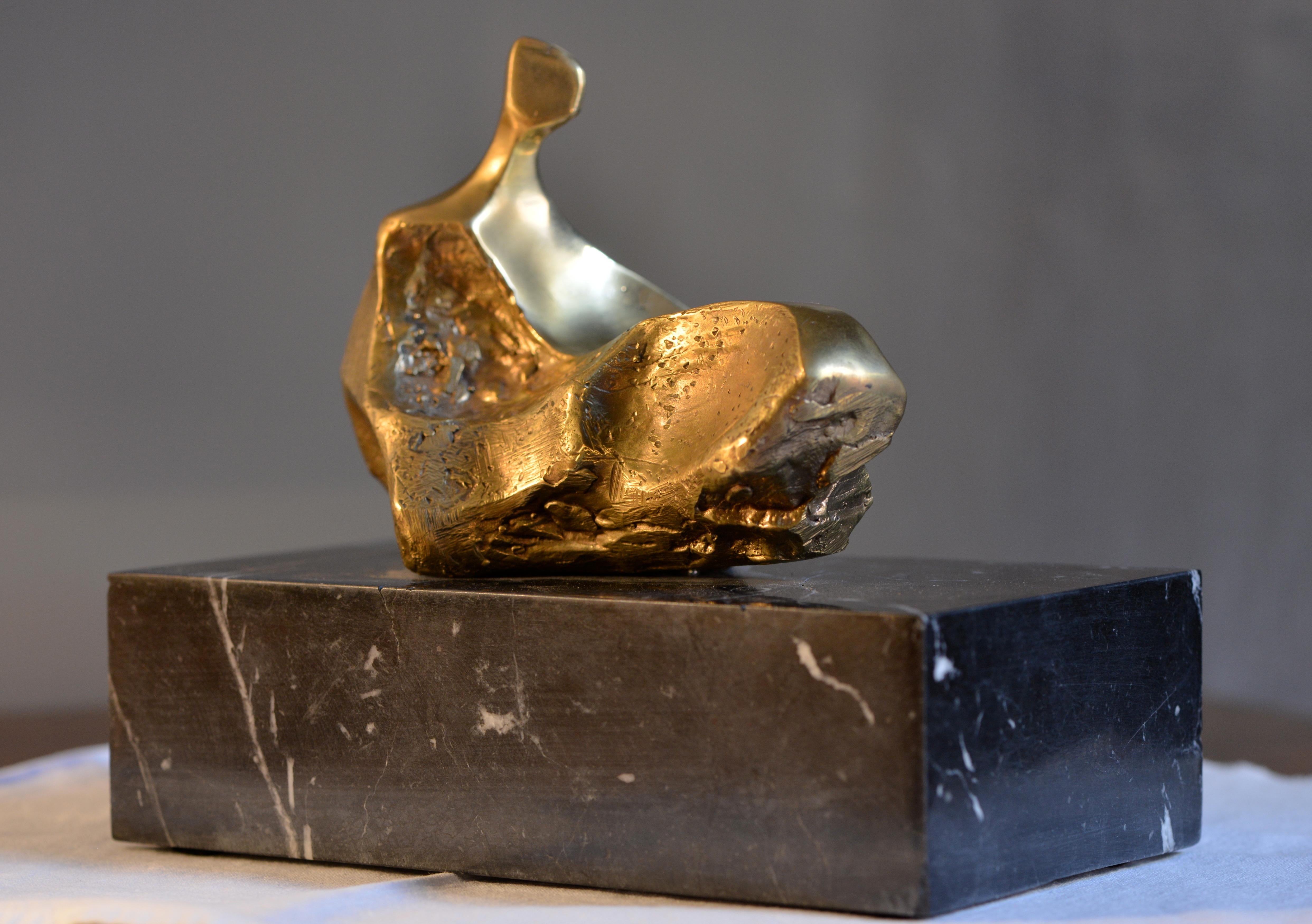 The sculpture (reclined female figure) is part of a series of 