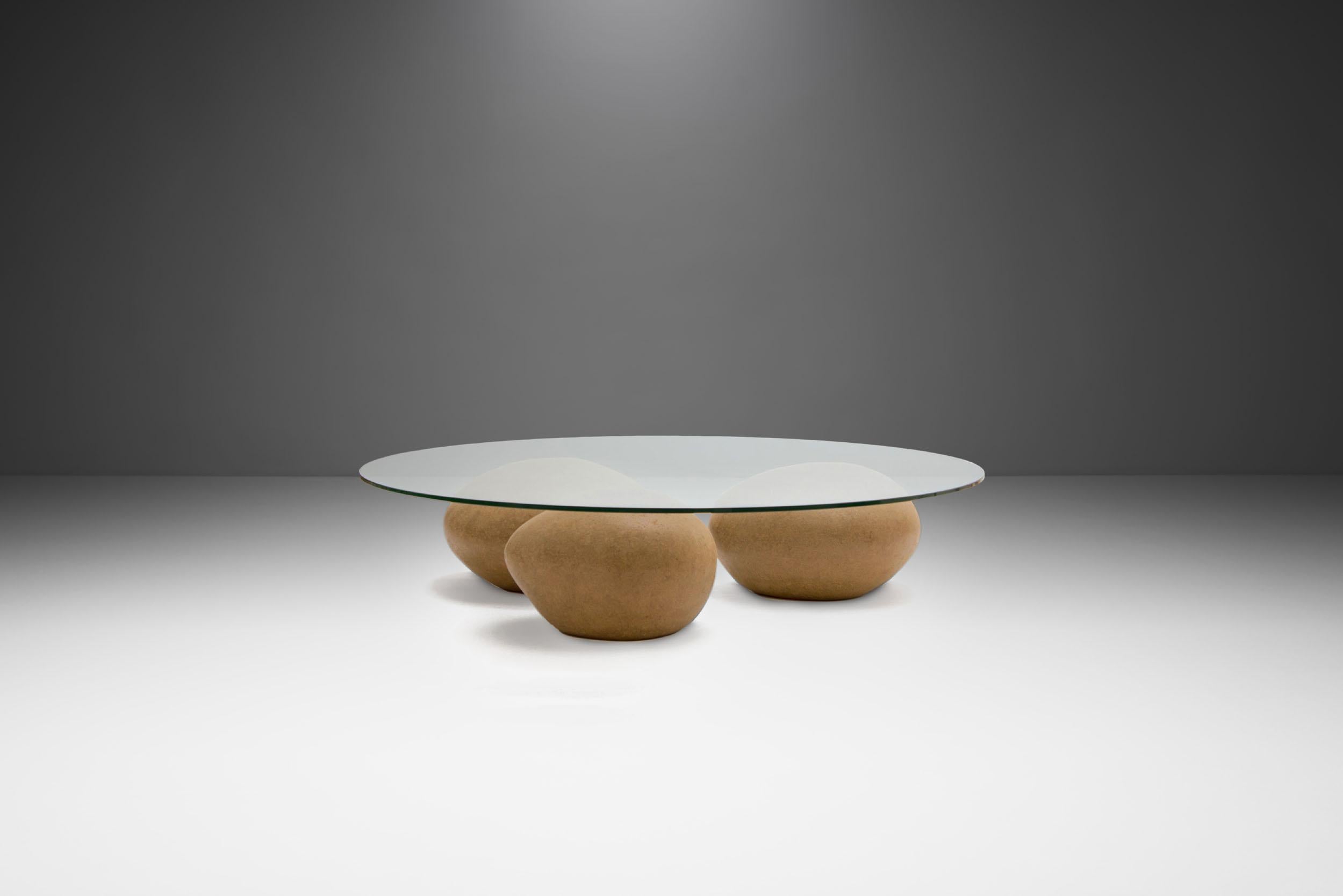This Água table by contemporary artist Domingos Tótora, is an exceptional piece. The name, meaning water in Portuguese speaks for itself.

The Água table comprises of three pebble-like shapes under a glass top that resemble water washing over
