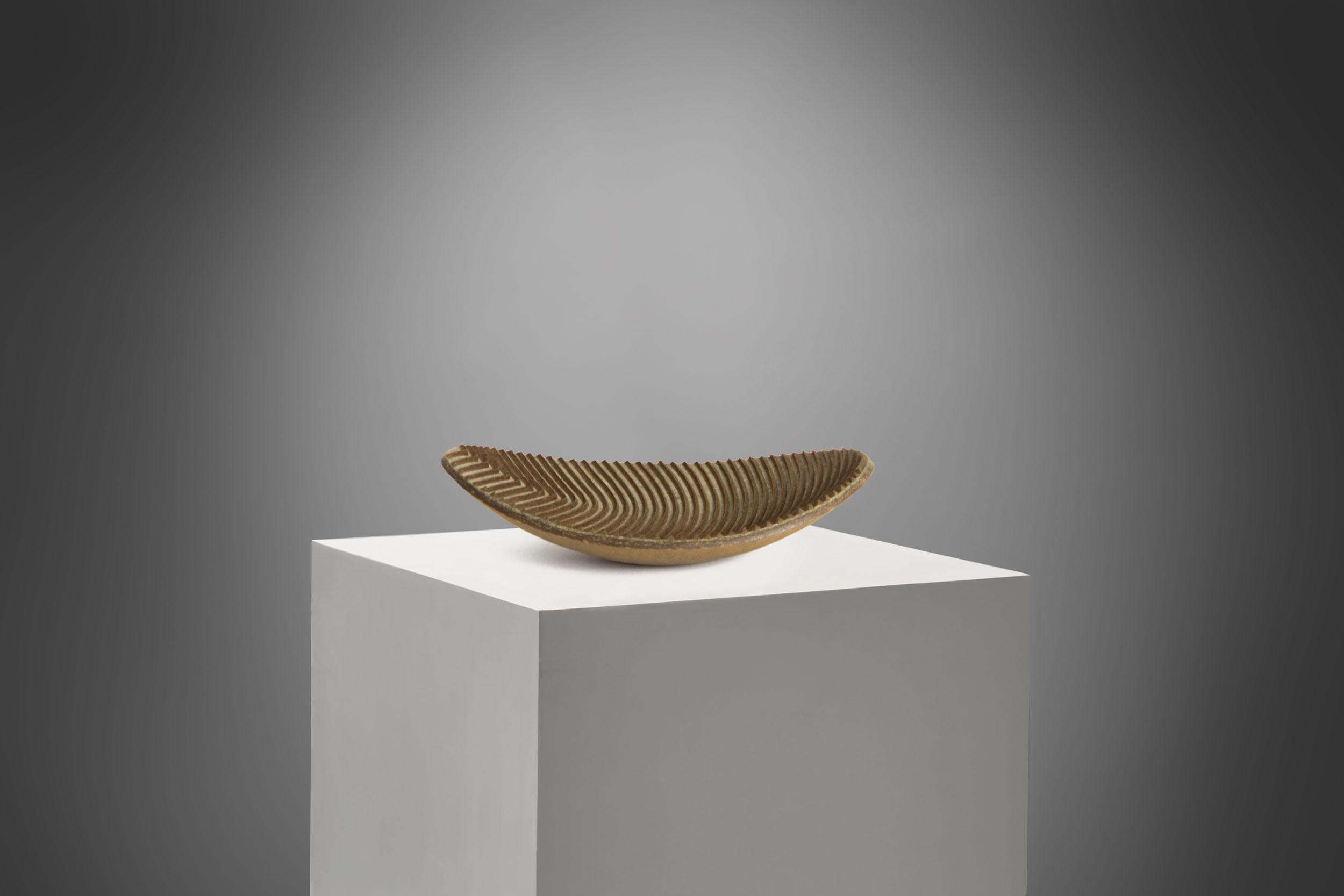 Organic bowl by contemporary artist Domingos Tótora. Made of recycled cardboard.

Domingos Tótora creates objects and sculptures where beauty is inseparable from function, lifting common everyday objects and injecting them with the spirit of Minas