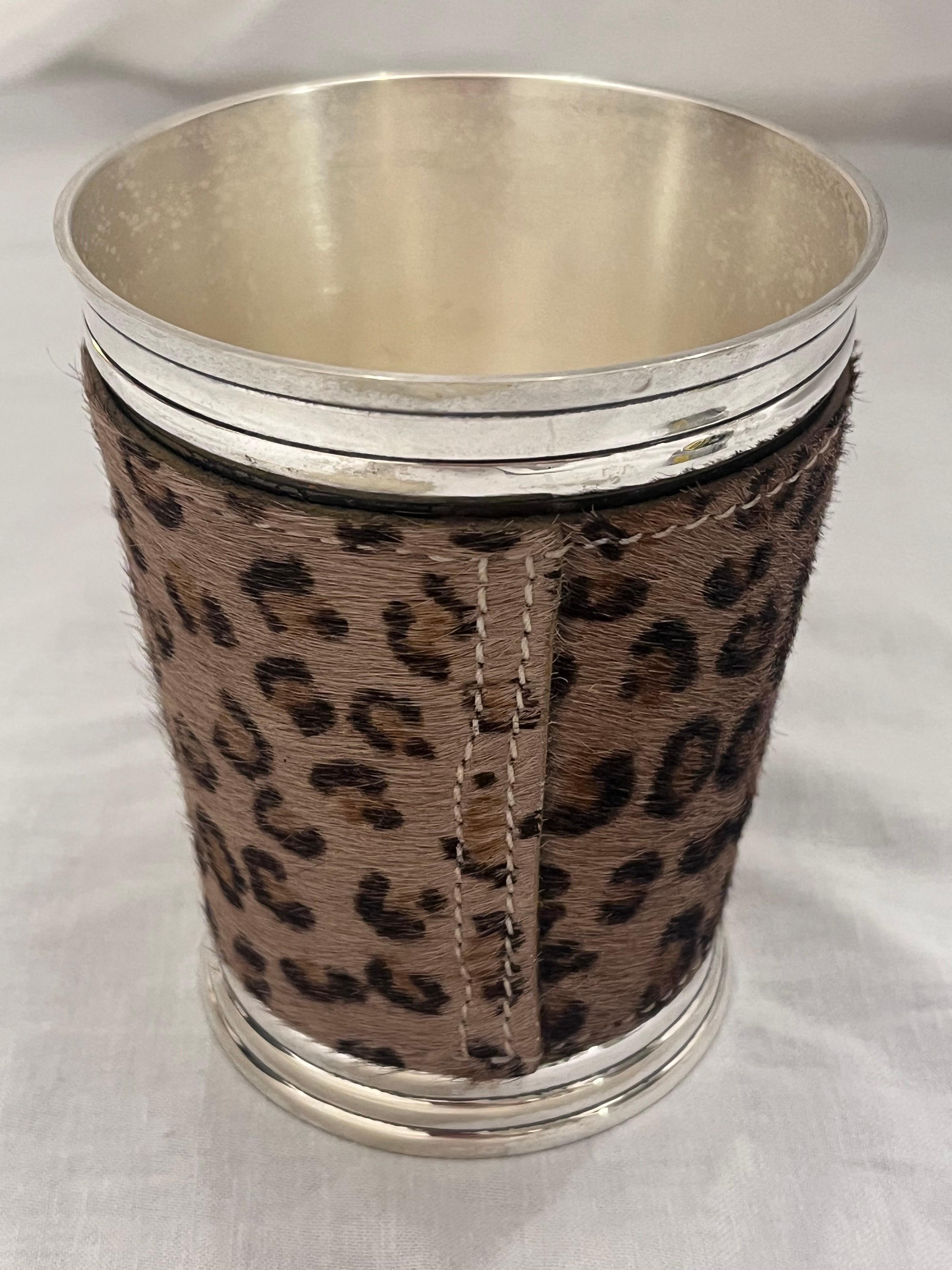 A striking, bold and hefty silvered metal beaker or cup by Dominic Chambon Paris. The vessel features a faux fur leather wrap around the outside of the cup. The lip and foot are both tiered in a strong architectural style. The weight of the beaker