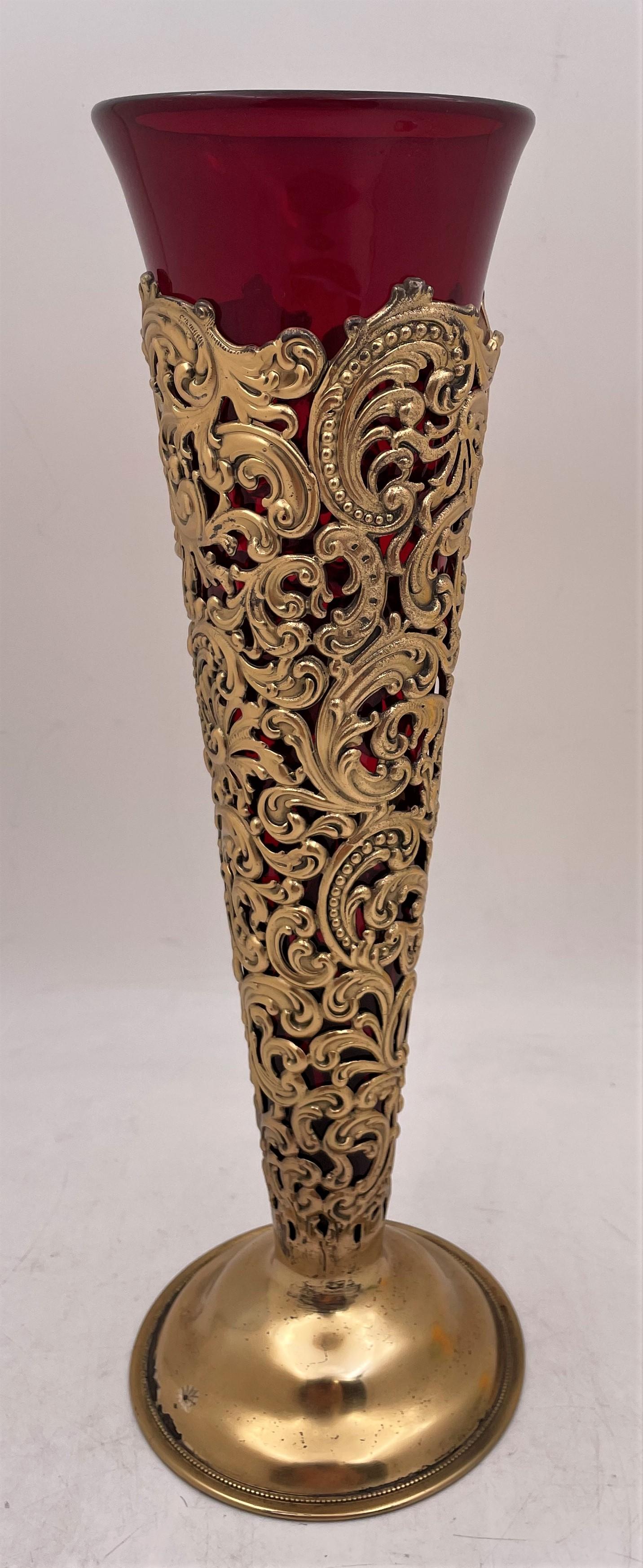 Dominick & Haff vermeil (gilt-sterling silver) vase from 1898 in pattern number 326A, with a richly adorned body showcasing elaborate, slightly raised, scroll-like motifs. It comes with a removable, red glass liner, measures 12 1/2'' in height (14