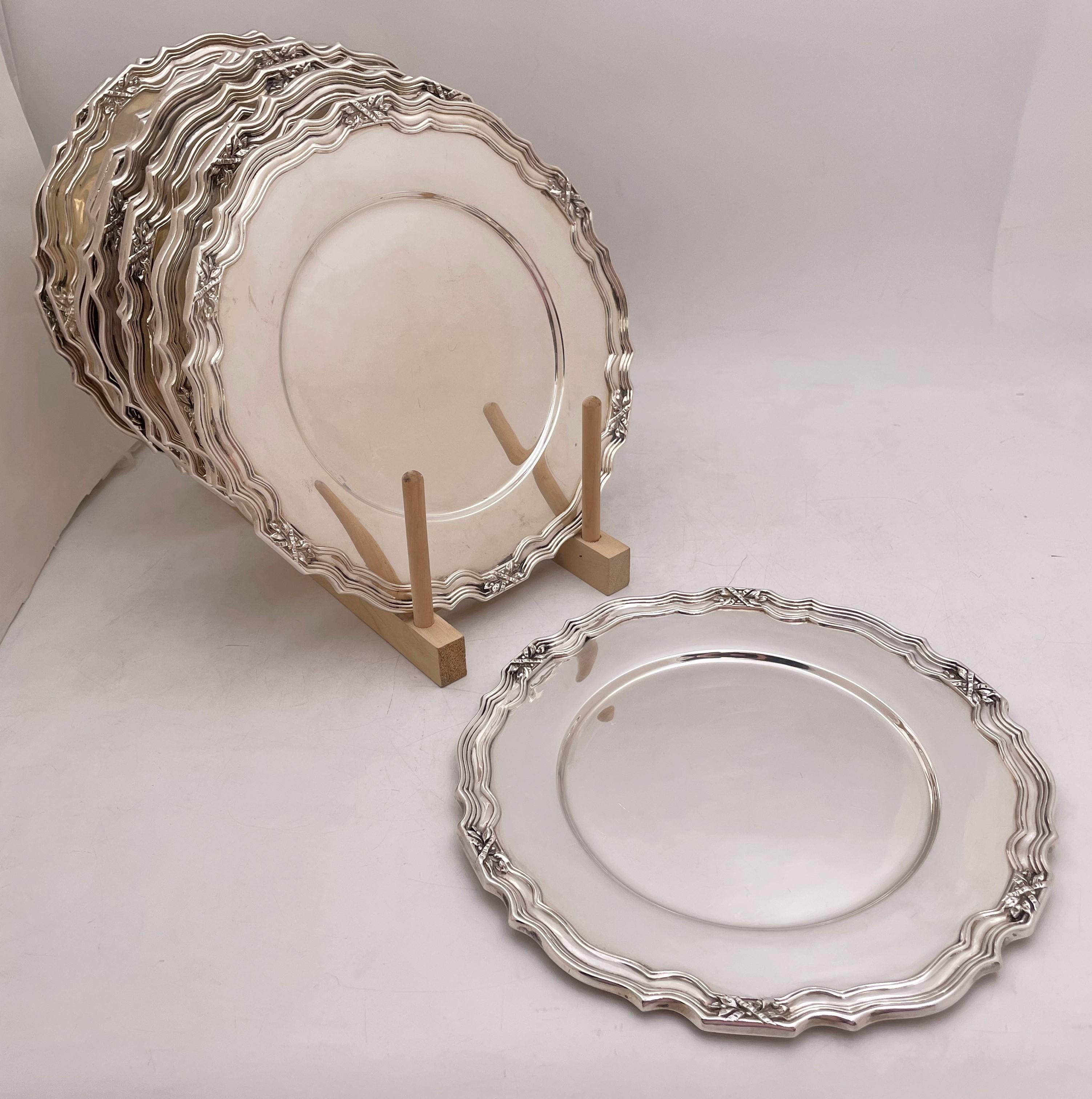 Dominick & Haff set of 12 sterling silver multilobed dinner plates or chargers from 1907, with floral motifs and curvilinear designs adorning the rim, with a heavy gage. Each measures almost 11'' in diameter by 3/4'' in height and bears hallmarks as