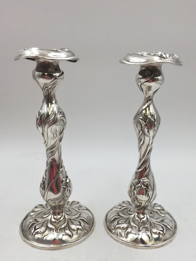 Pair of Dominick & Haff / Mauser sterling silver candlesticks from 1903 in exquisite Art Nouveau style with raised natural motifs, measuring 10 1/4'' in height by 4 1/2'' in diameter at the base, and bearing hallmarks and monograms as