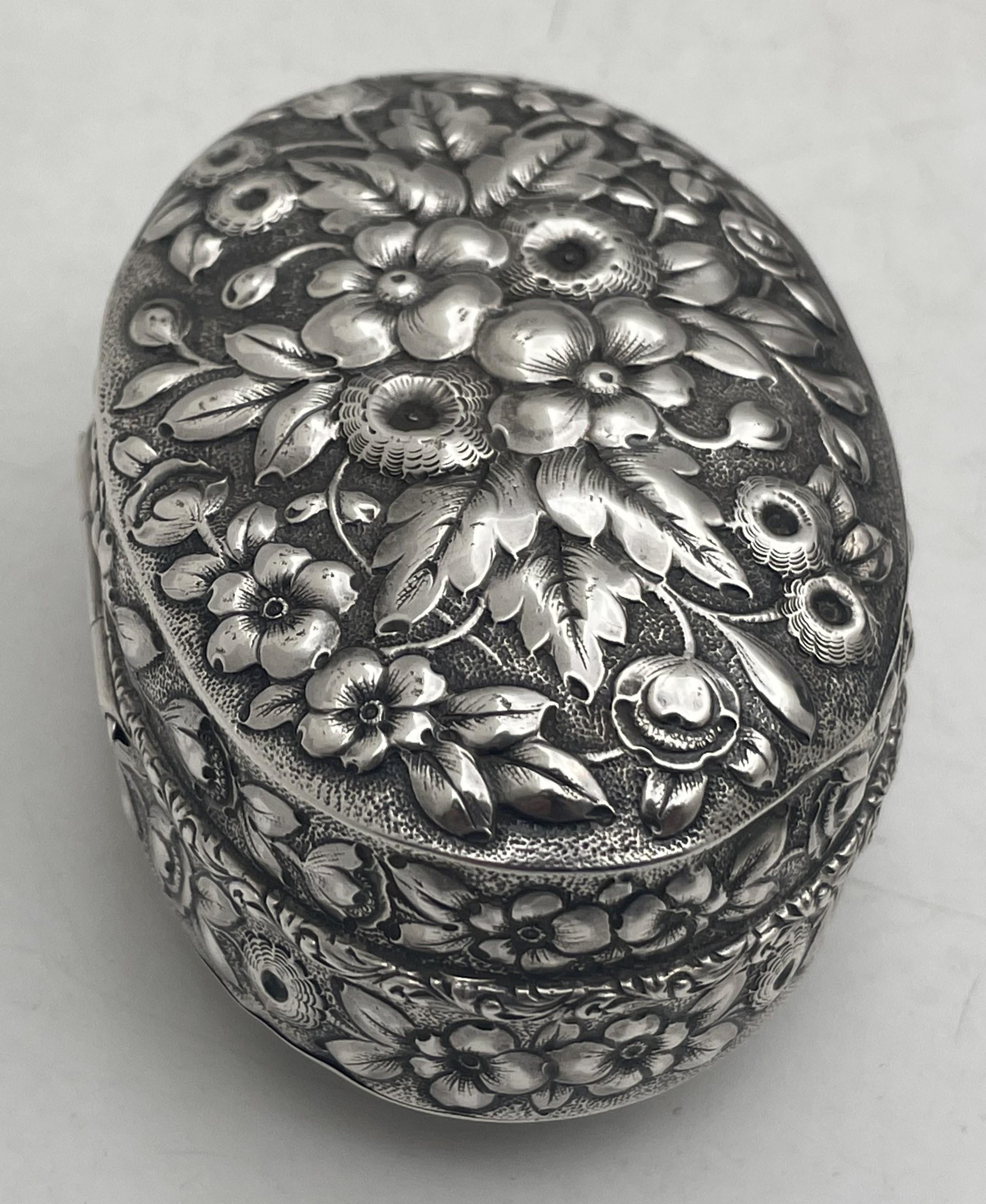 Dominick & Haff for Bailey, Banks & Biddle sterling silver oval snuff box in repousse pattern, beautifully adorned with floral motifs. It measures 3 3/8'' by 2 1/2'' by 1 5/8'' in height, and bears hallmarks as shown.

Dominick & Haff was an