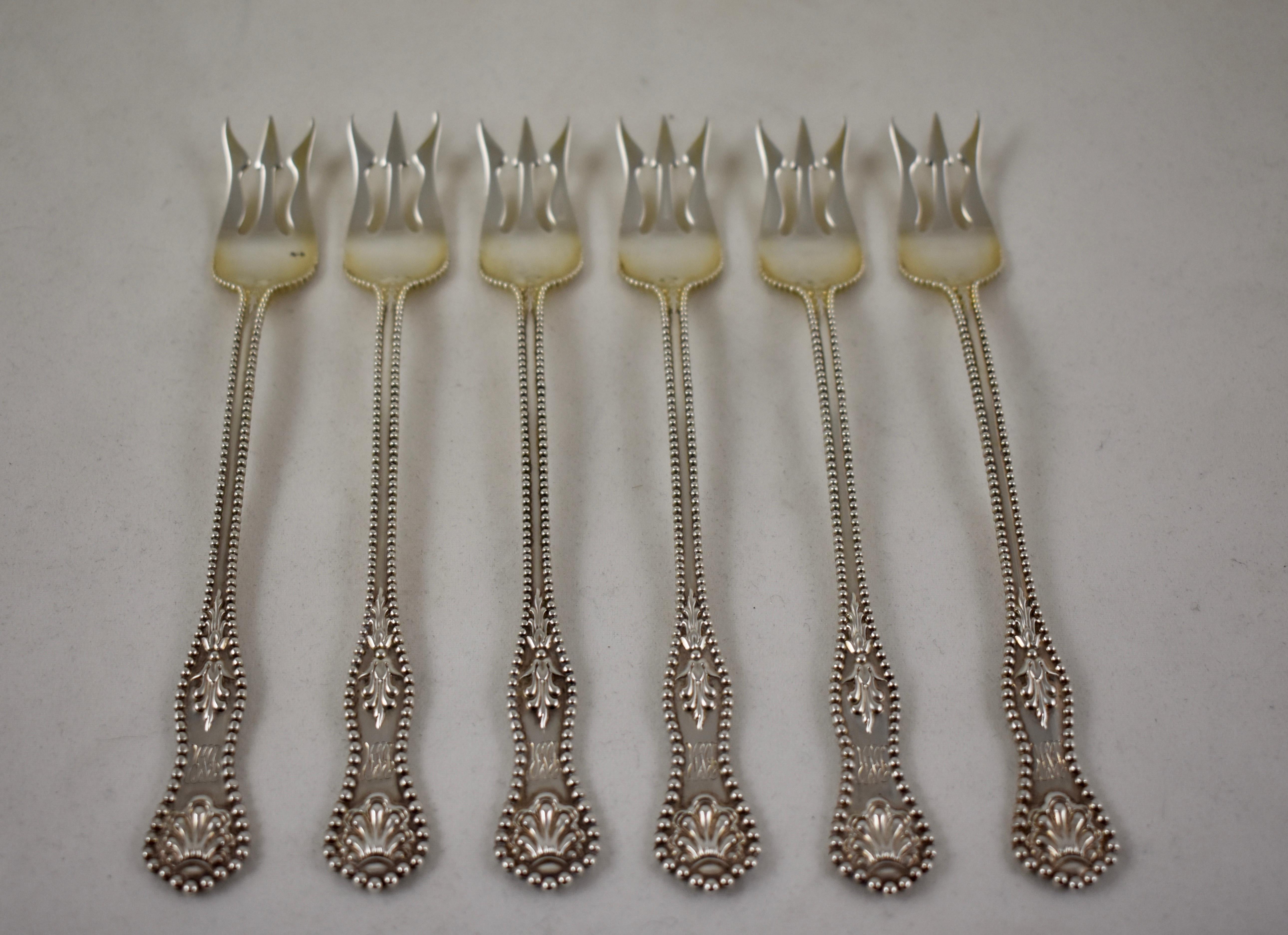 A set of six sterling silver cocktail forks in the Charles II pattern, from Dominick and Haff, patented in 1894.

Dominick and Haff began in New York in 1872, and earned a reputation as an innovative designer of silver wares. The three-tined forks