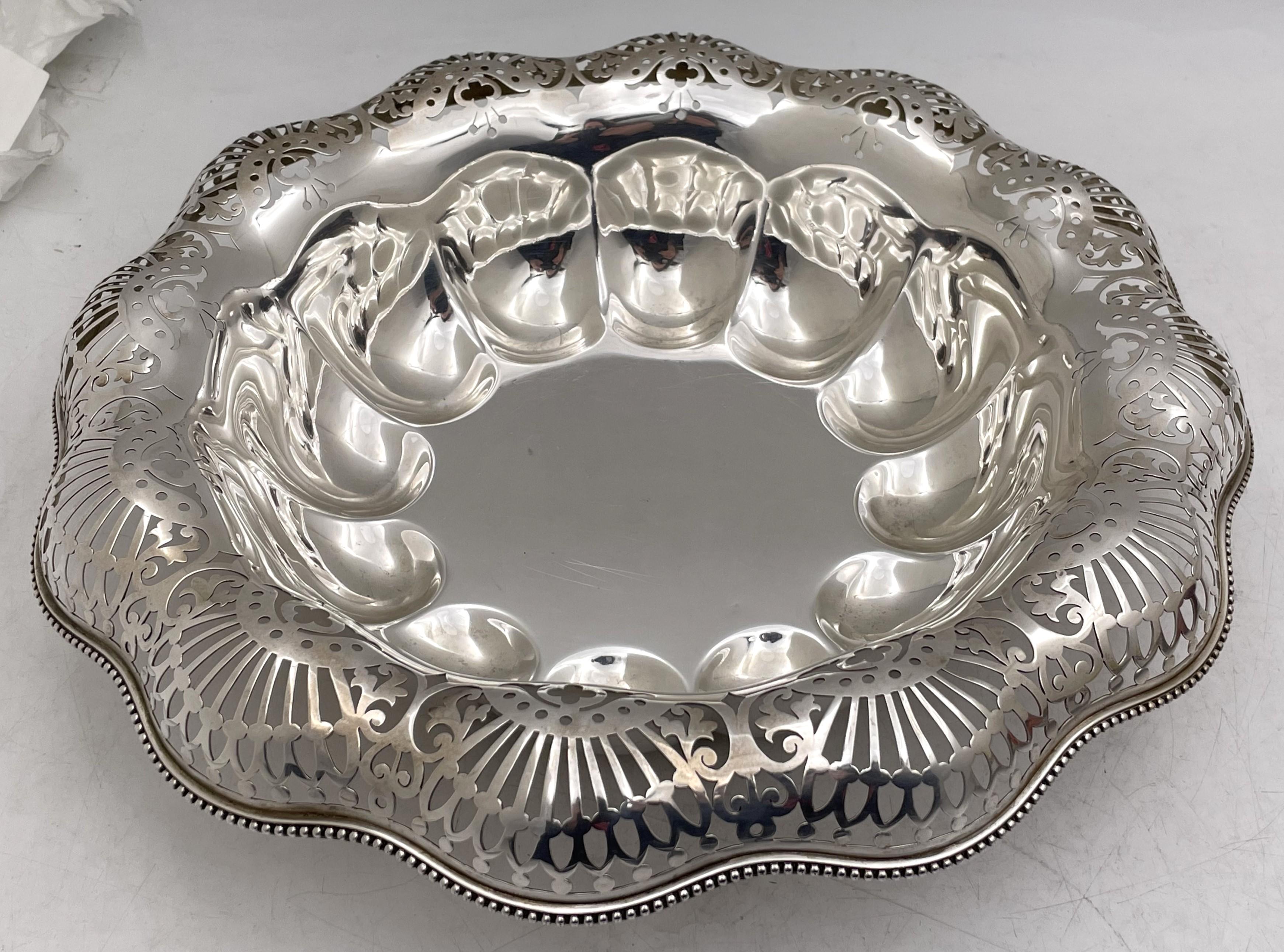 Dominick & Haff sterling silver multilobed centerpiece bowl from 1887, showcasing stylized geometric pierced motifs on the rim. It measures 13'' in diameter by 3 1/4'' in height, weighs 25.5 troy ounces, and bears hallmarks as shown. 

Dominick &