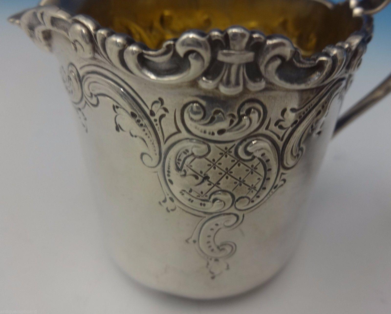 Dominick and Haff
This sterling silver sugar bowl and creamer 2-piece set was made by Dominick and Haff in 1891. The design features repoussed scrollwork with hand engraved detail. The pieces are marked #522 and were retailed by the store Spaulding