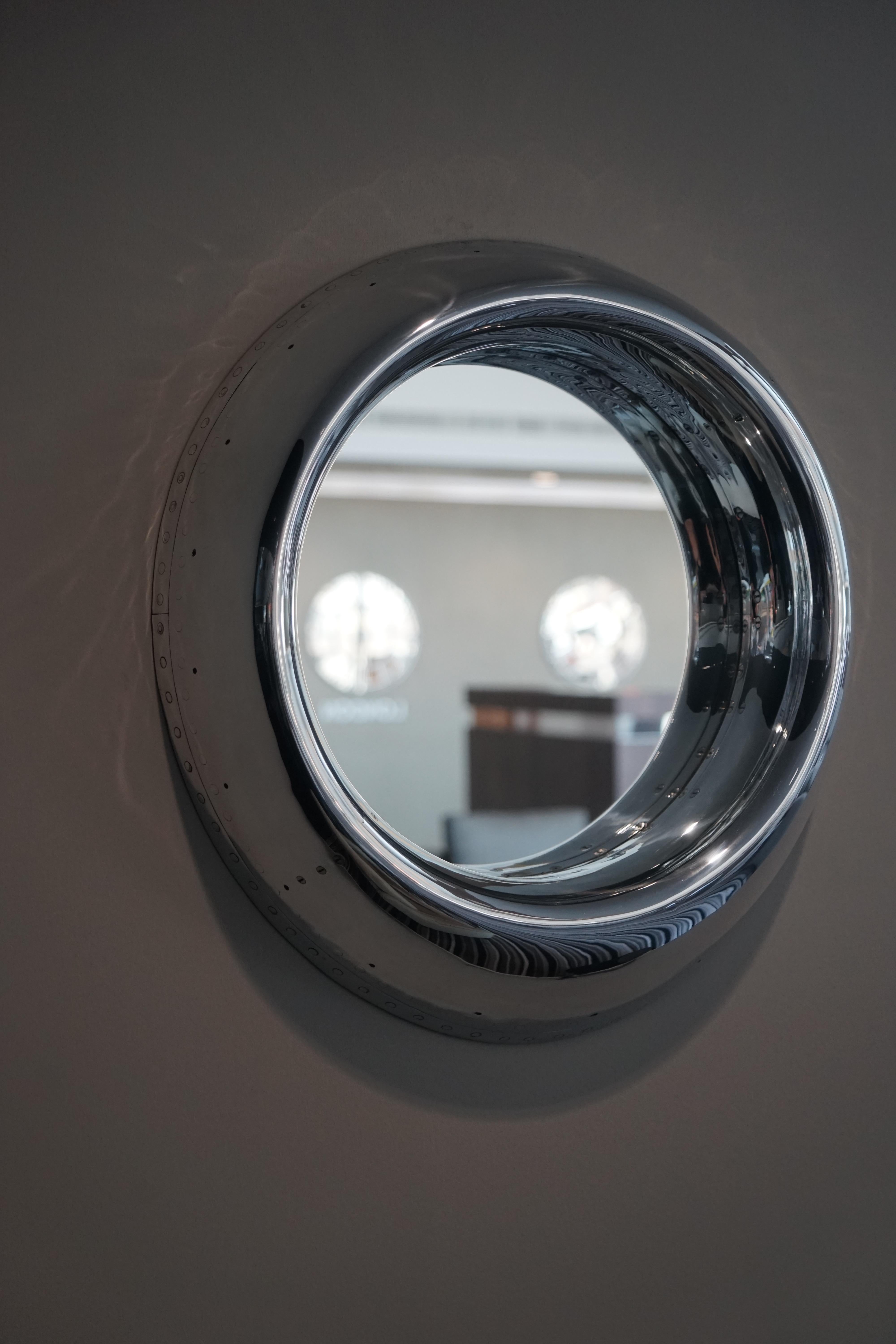 A highly polished engine cowling's leading edge, from a Dominie Twin Jet Business Aircraft. Fitted within the centre of the cowling a mirror.

 